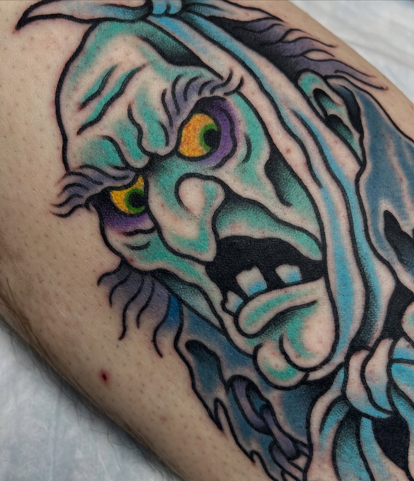 Mask American traditional tattoo on the forearm by Tom Taylor, Philadelphia, Pennsylvania