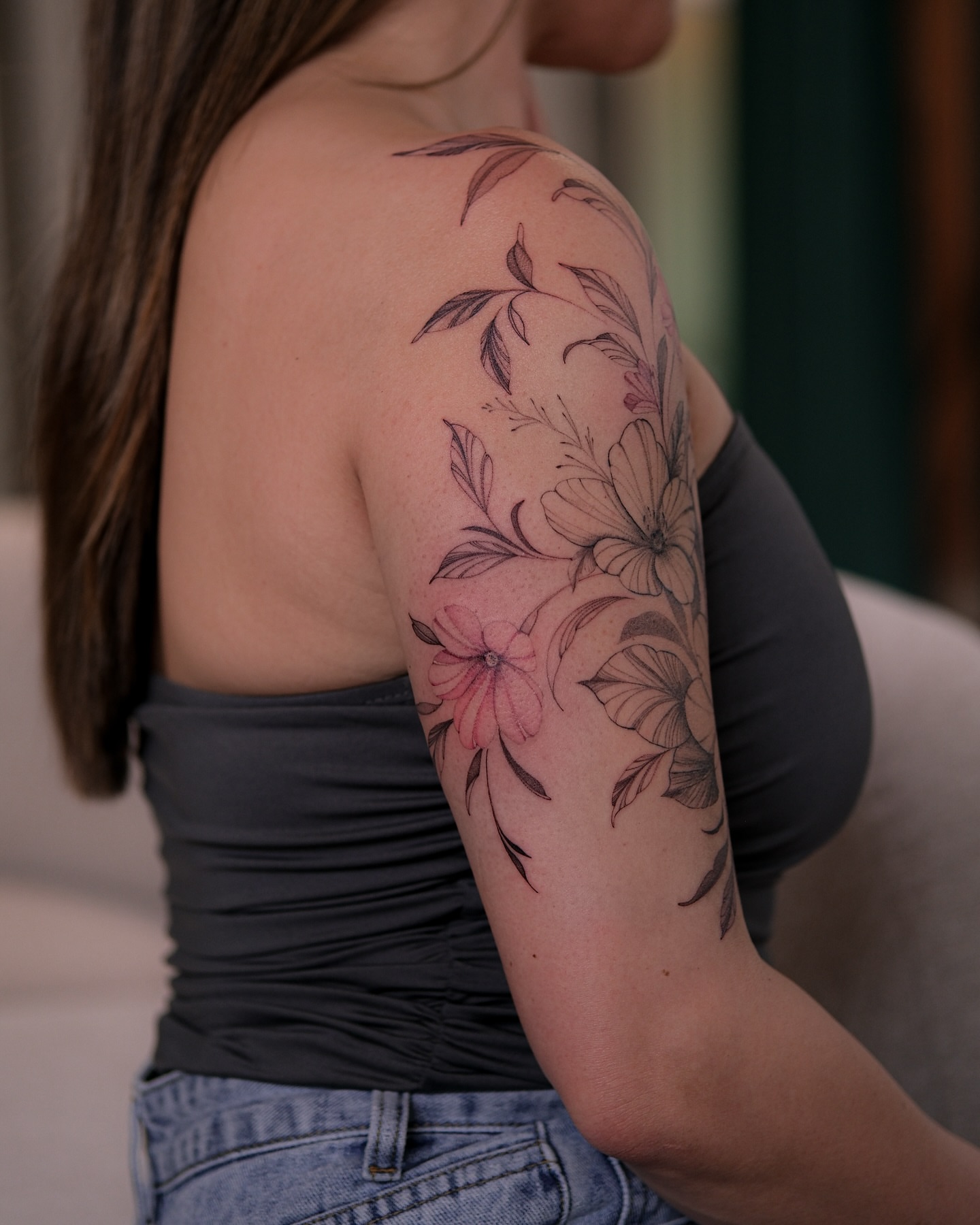 Floral arrangement realism tattoo on the upper arm by Flower Tattoo Sf