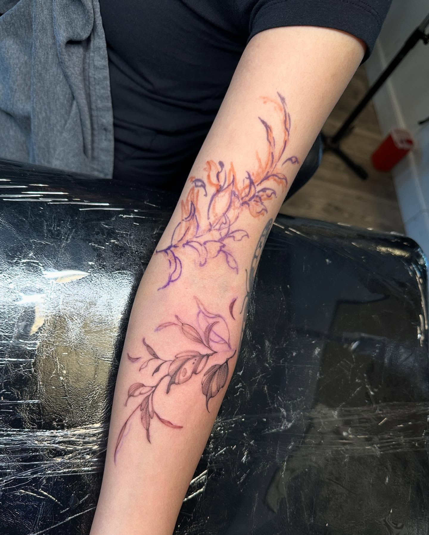Floral design fine line tattoo on the forearm by Angel