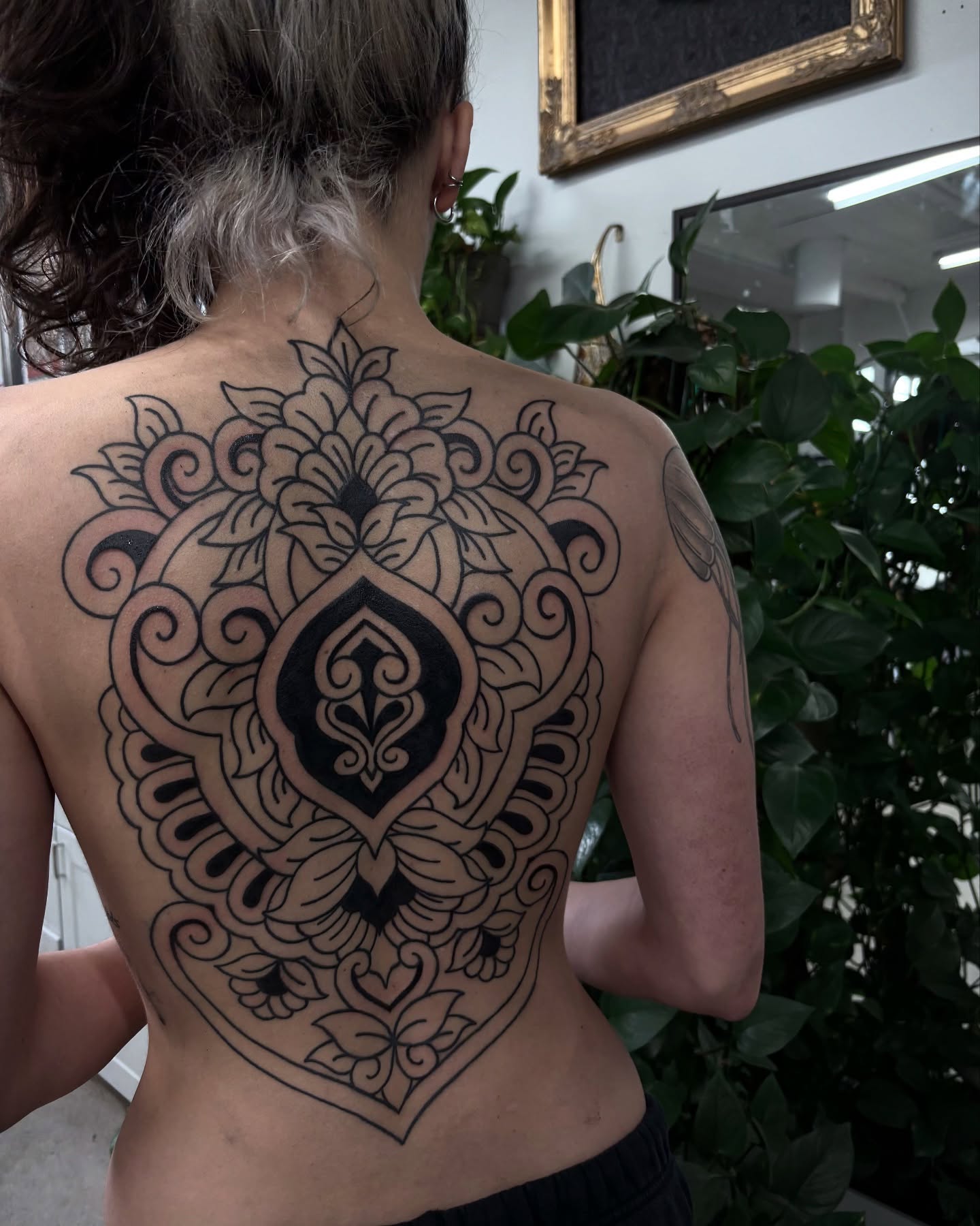 Mandala ornamental tattoo on the back by Kolbi Alexis