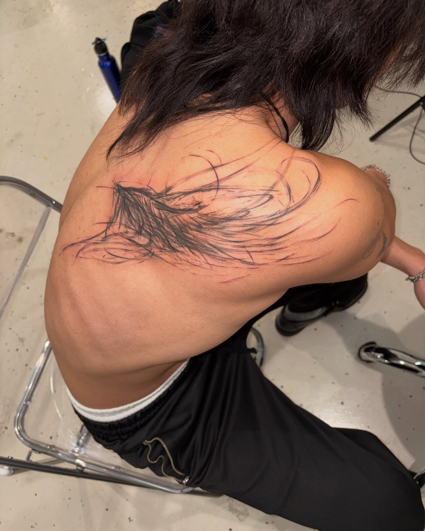 Feather black and grey tattoo on the shoulder by Young one 영원
