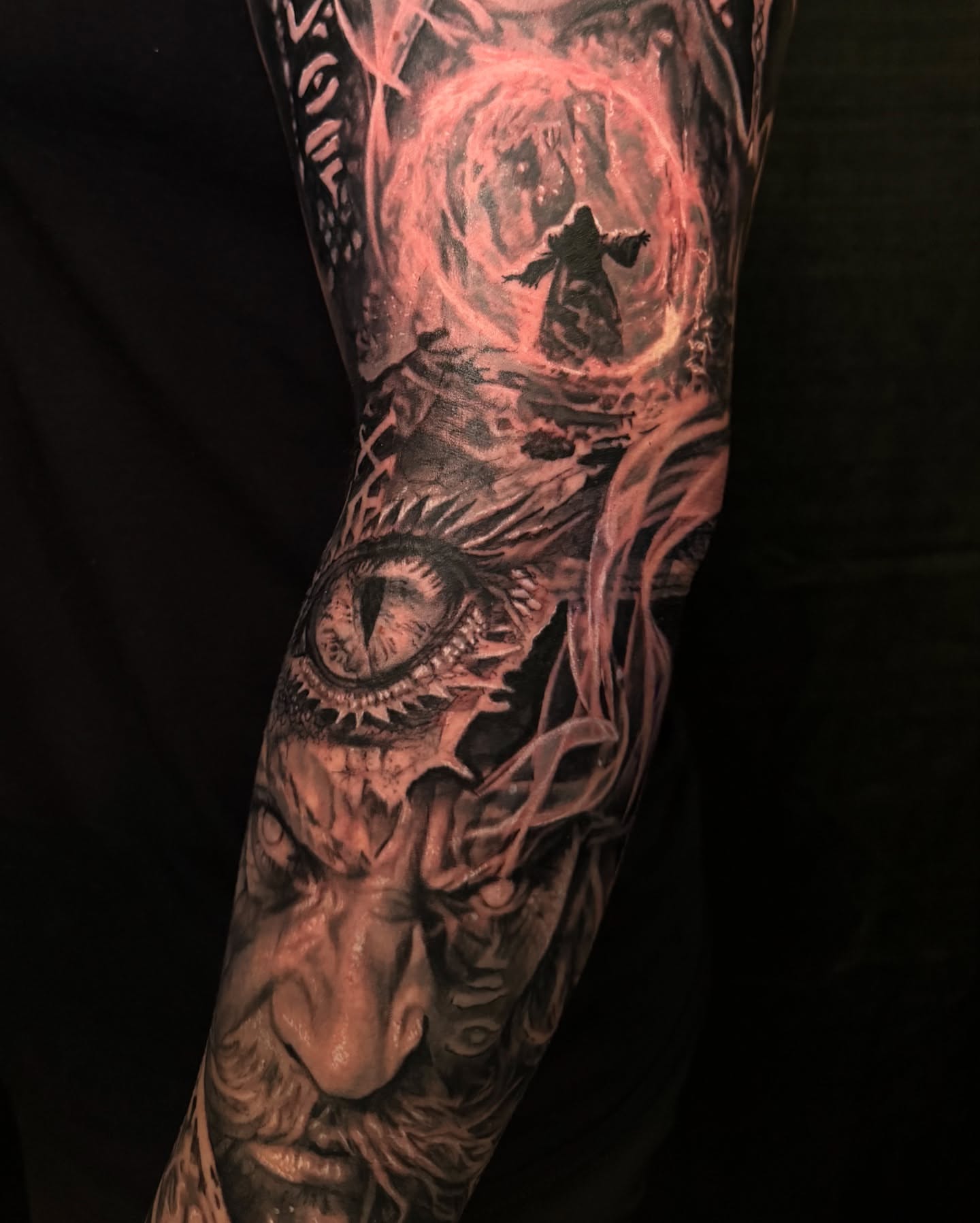 Eye and figure dark realism tattoo on the forearm by Alia