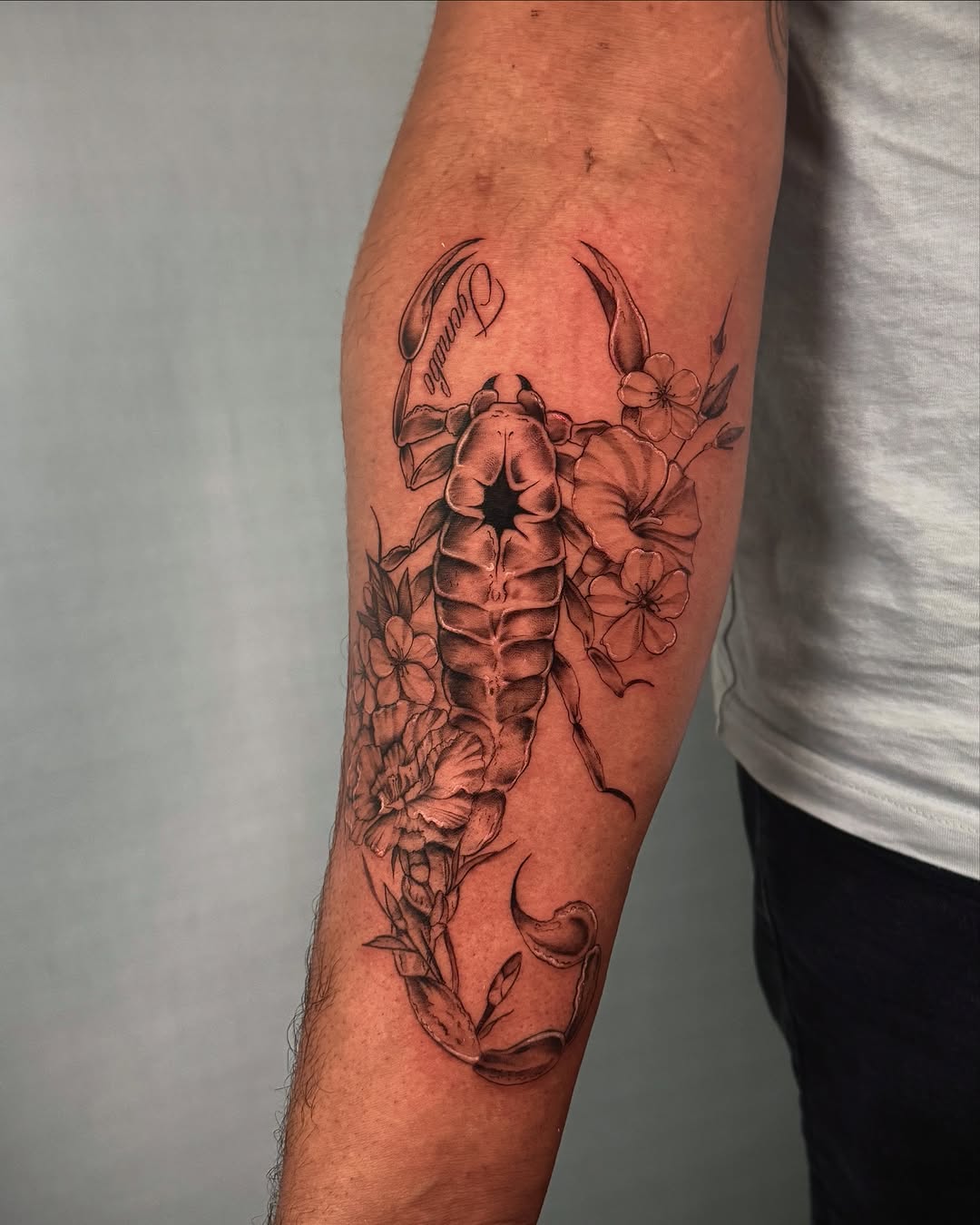 Scorpion and flowers fine line tattoo on the forearm by Nyc Tattoo Manhattan