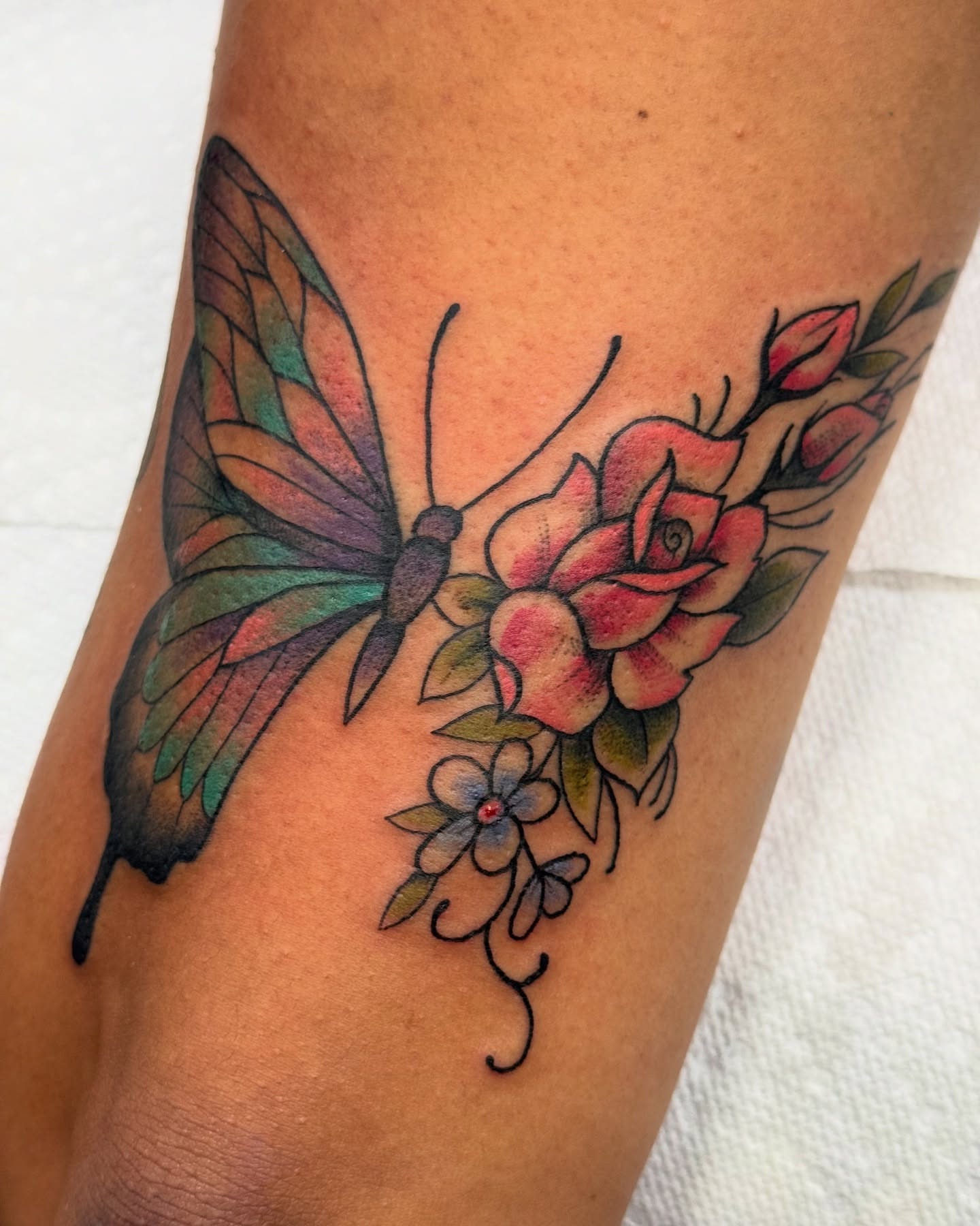 Butterfly and roses new school tattoo on the forearm by jenna clark🎨