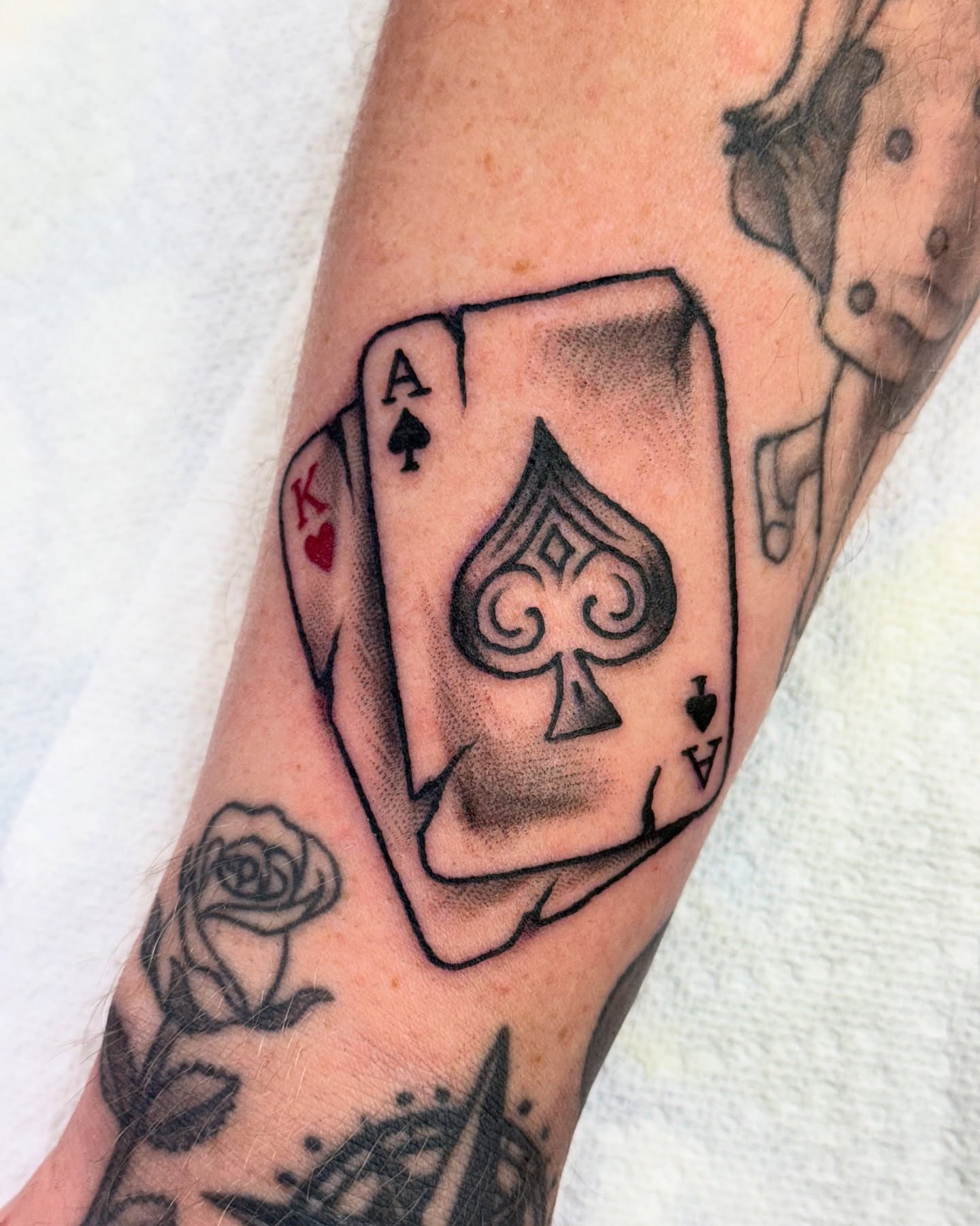 Playing cards American traditional tattoo on the forearm by jenna clark🎨