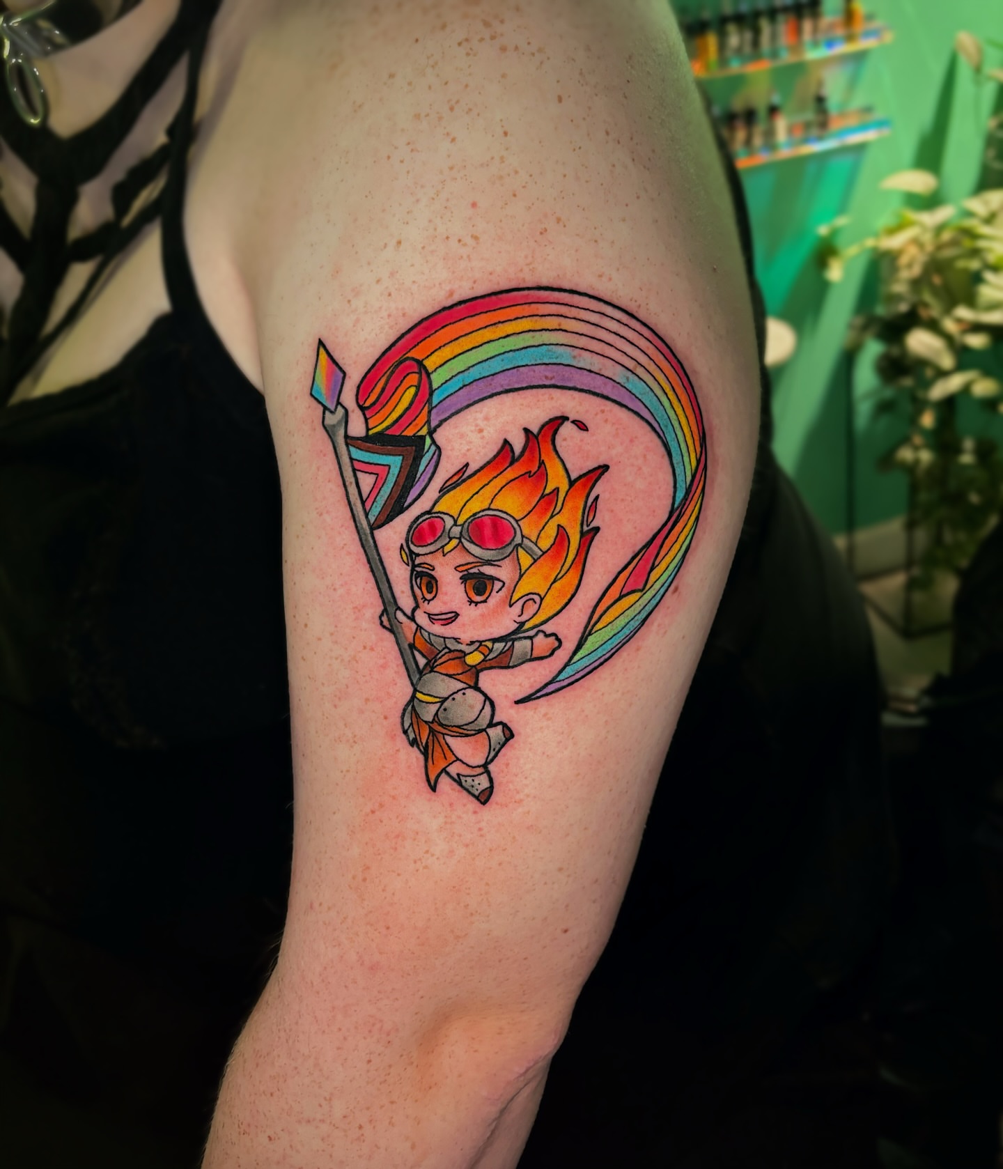 Chibi character with rainbow new school tattoo on the forearm by Bunny Noel