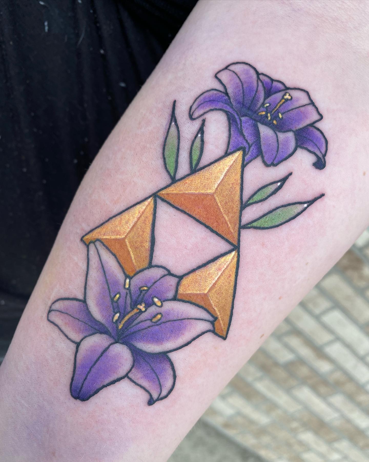 Lilies and geometric shape geometric tattoo on the forearm by Savanna Starr Mortensen