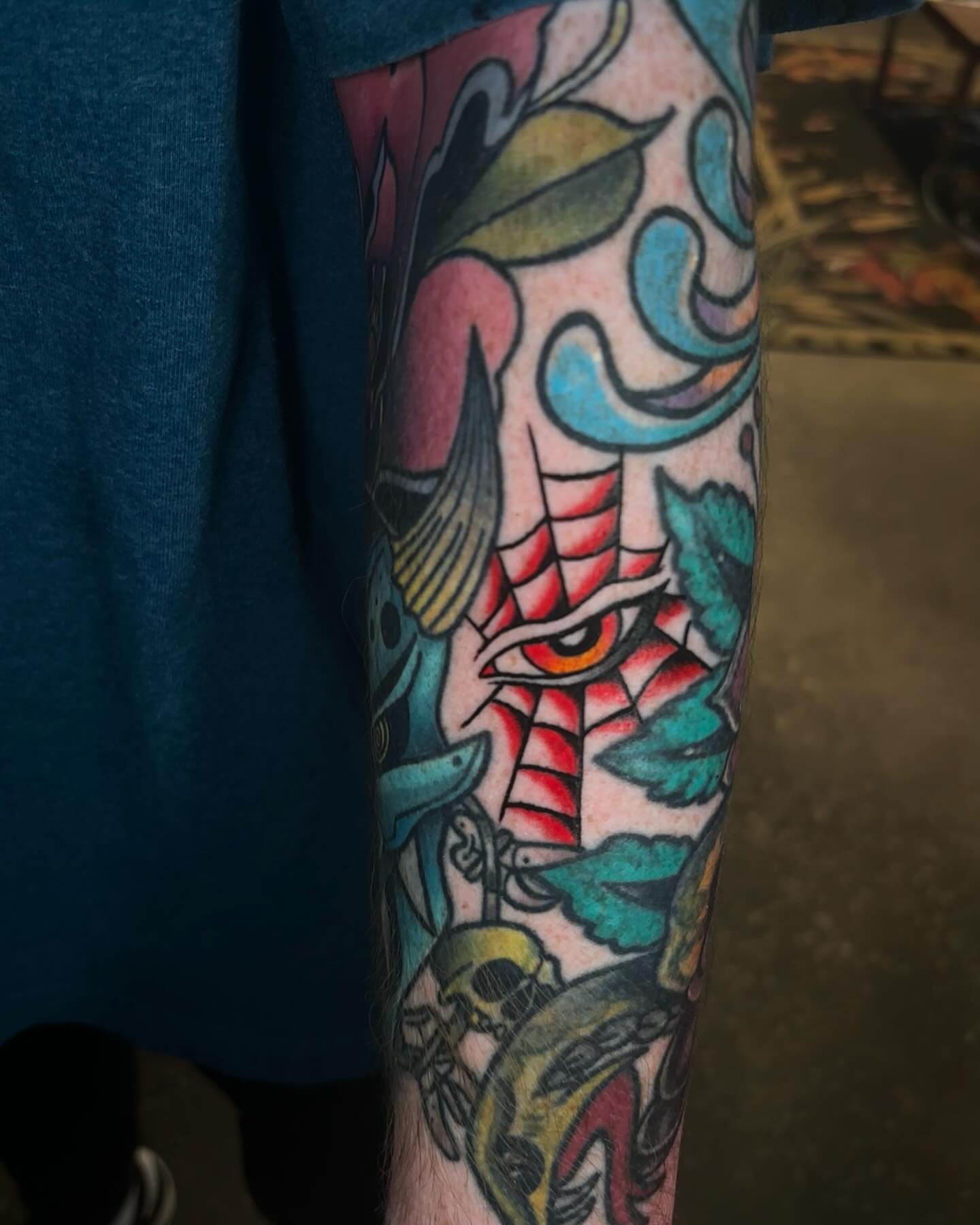 Eye and fish American traditional tattoo on the forearm by Brett Ferguson