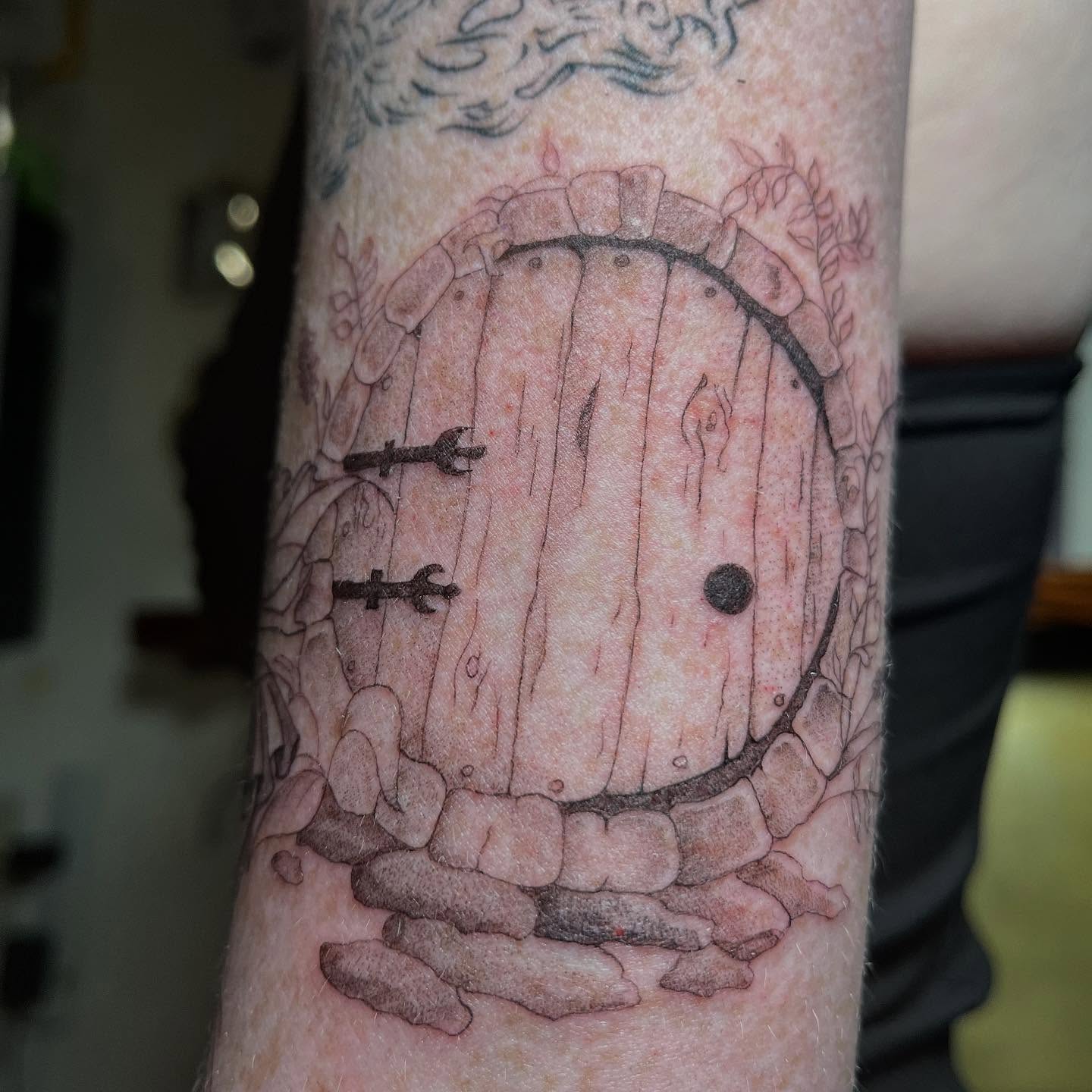 Hobbit door dotwork tattoo on the forearm by San Diego tattoo artist
