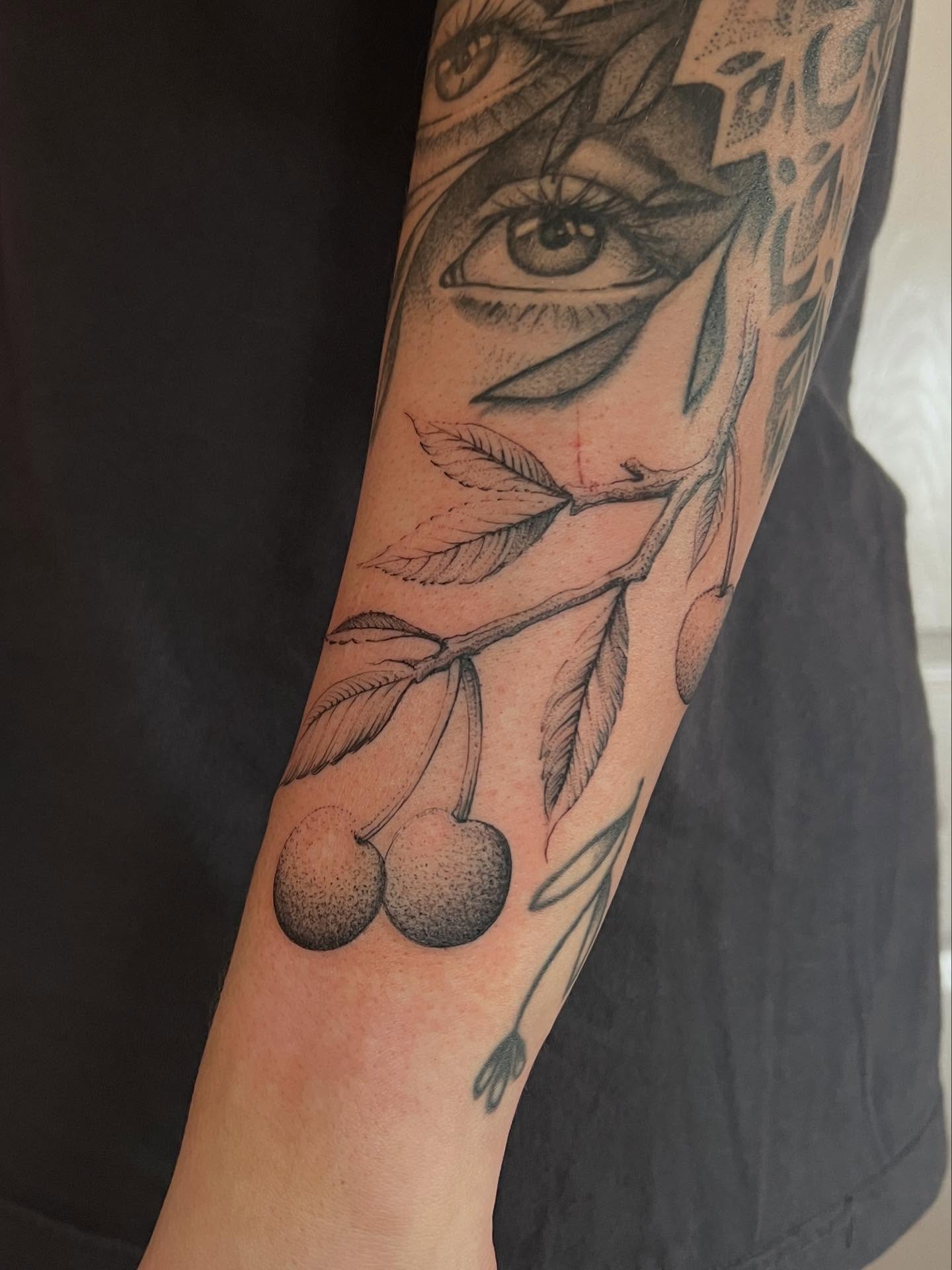 Cherry branch dotwork tattoo on the forearm by Natasha