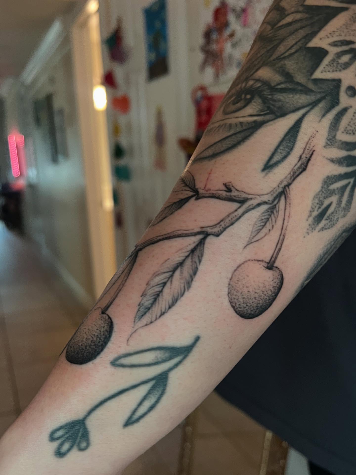 Cherry branch dotwork tattoo on the forearm by Natasha