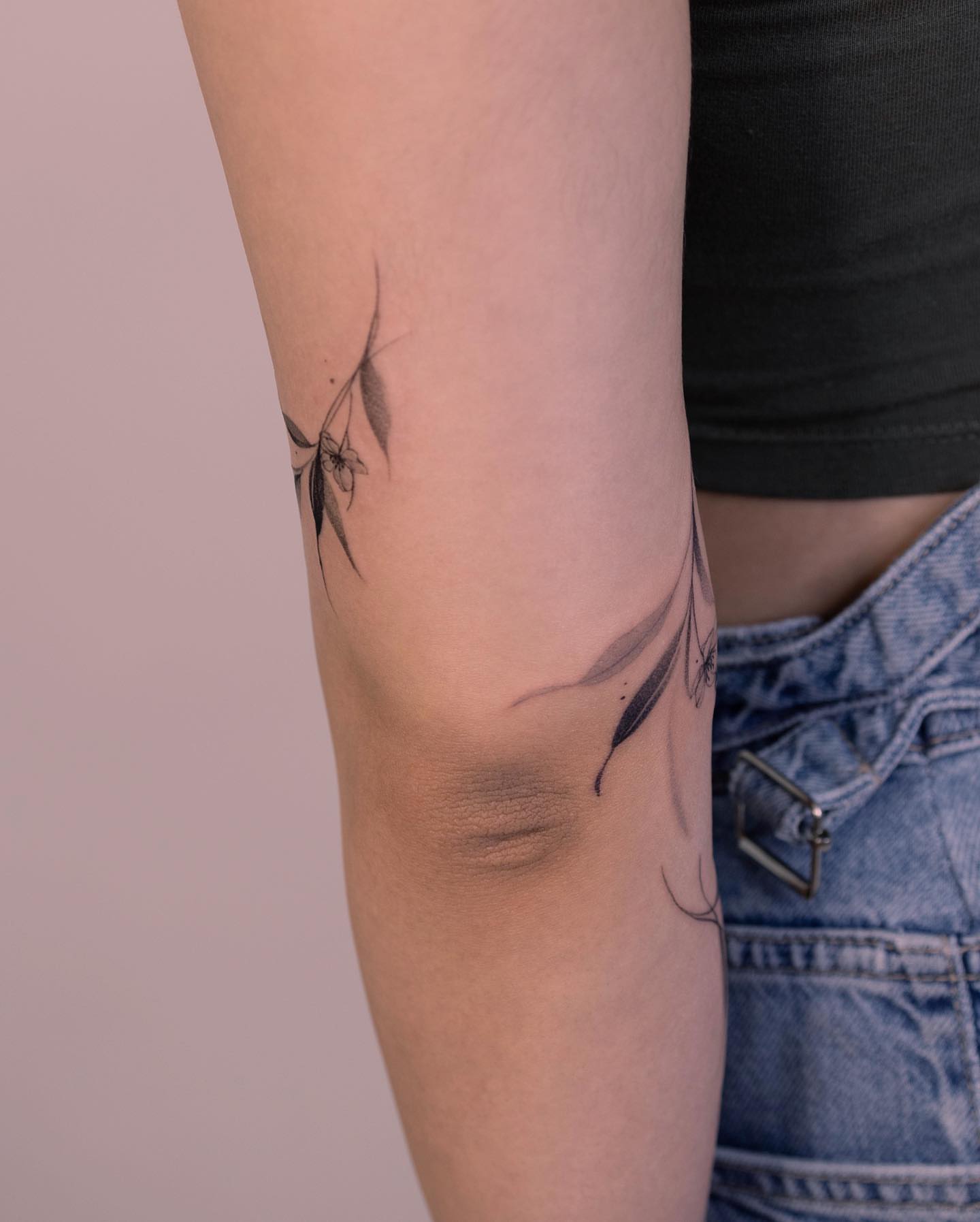 Feather black and grey tattoo on the forearm by Tattooist hea