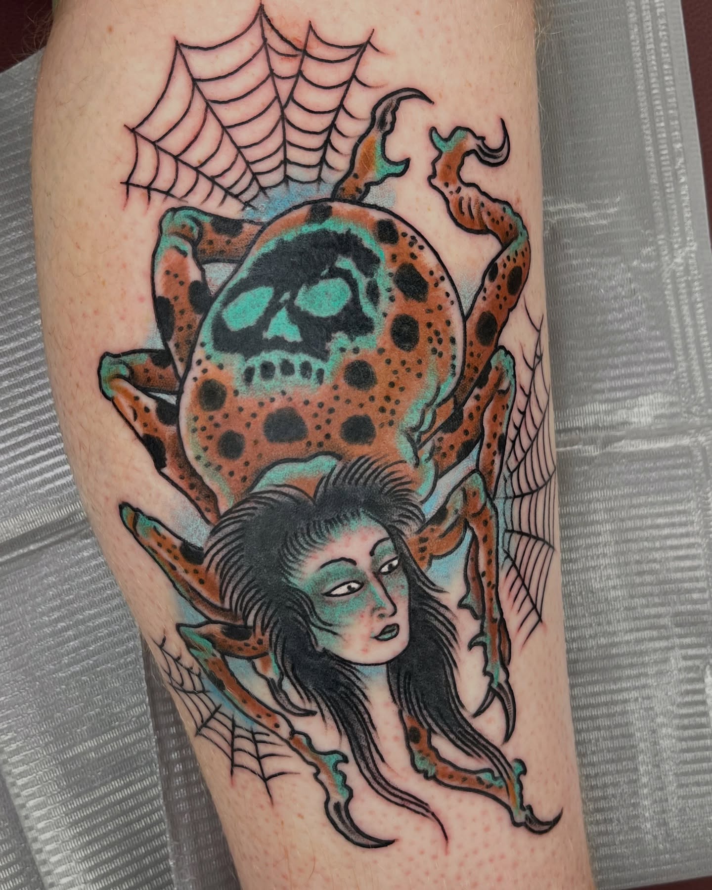 Spider and woman American traditional tattoo on the forearm by Steve Tiberi