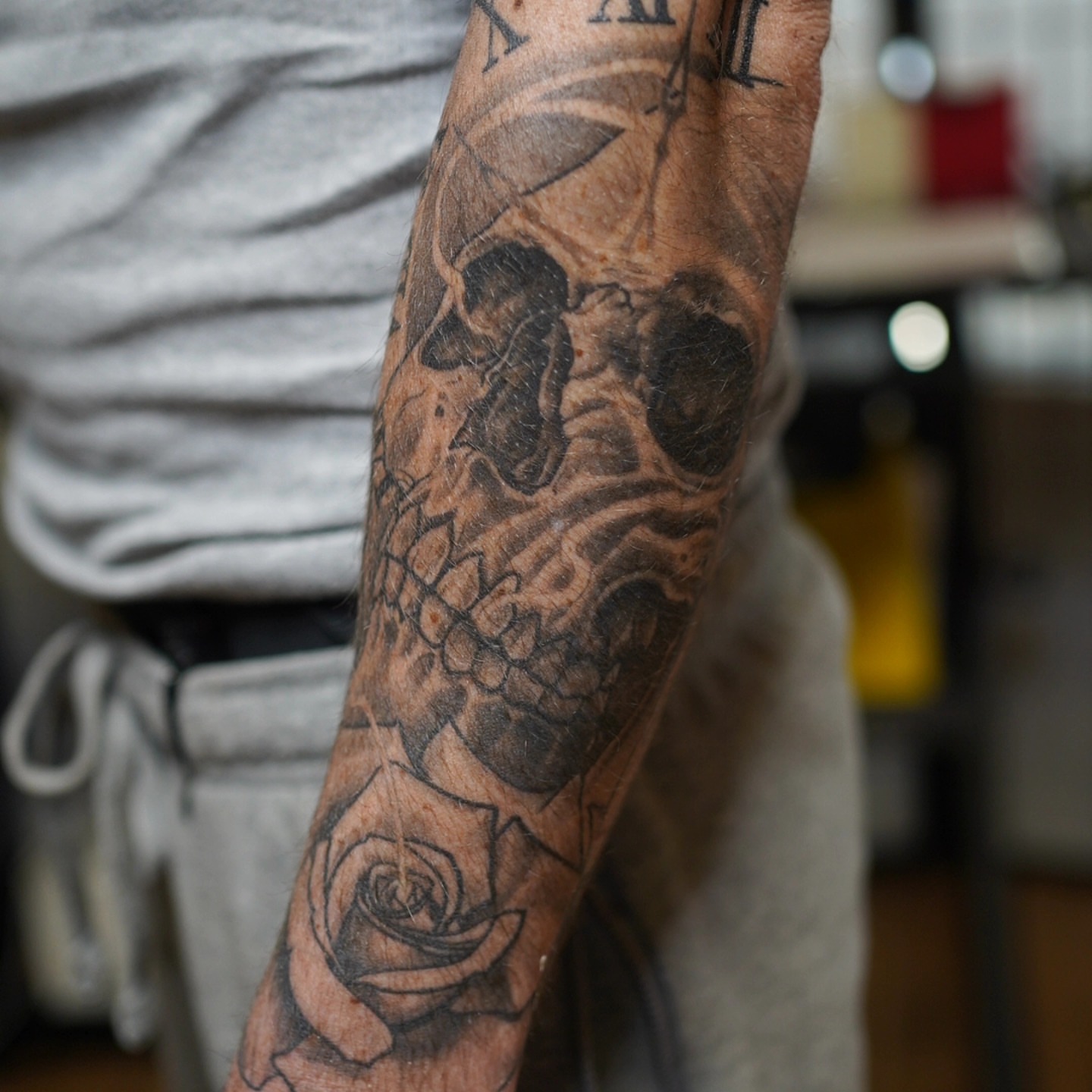 Skull and roses realism tattoo on the forearm by Anthony Moncada
