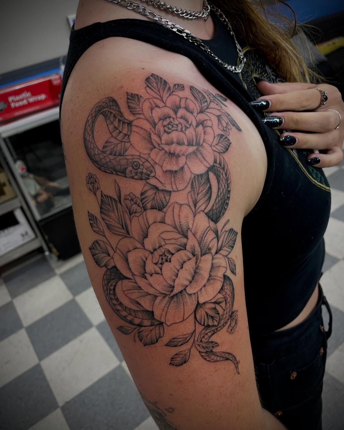 Snake and peony black and grey tattoo on the shoulder by Manny