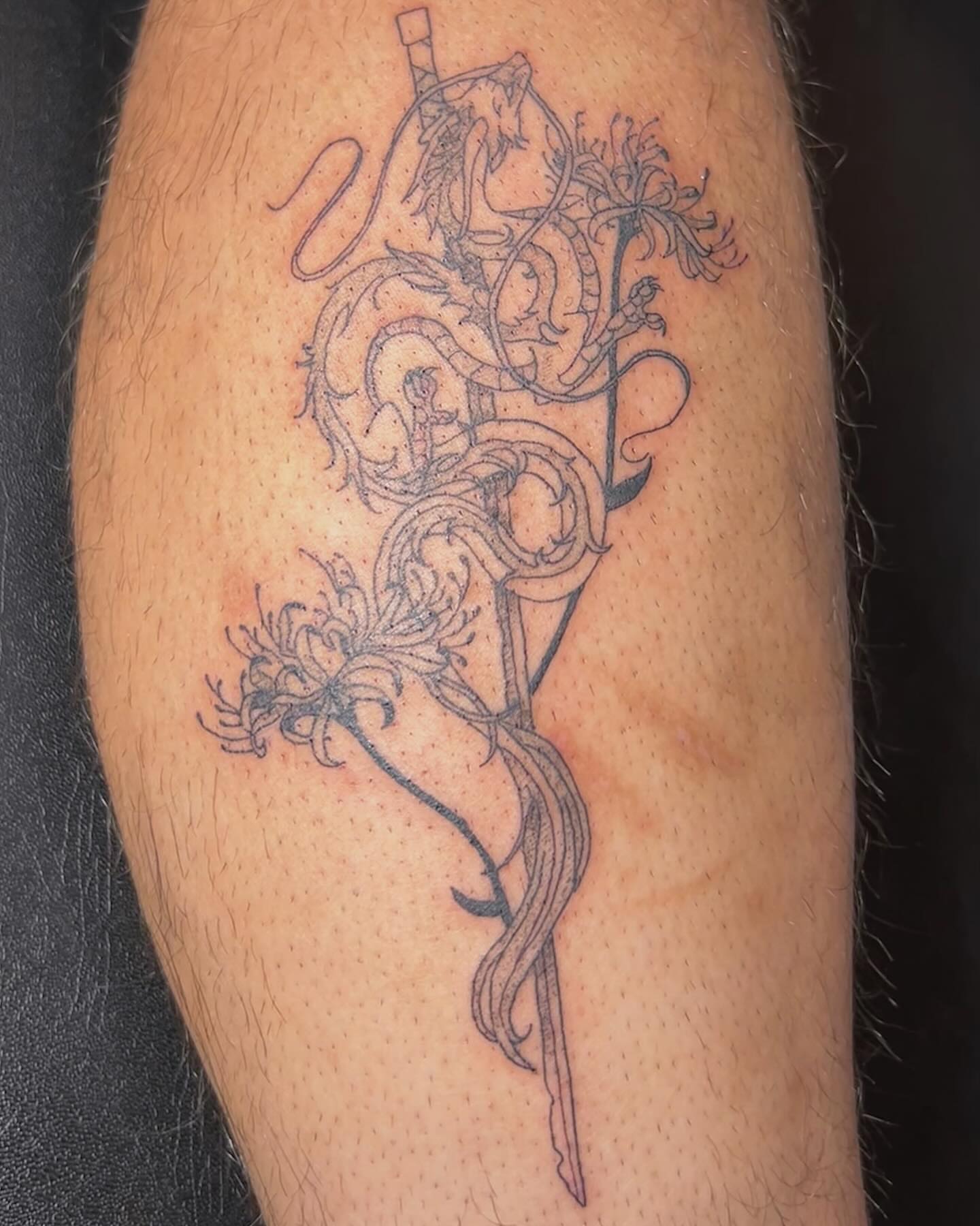 Serpent and flowers black and grey tattoo on the forearm by goose 🪿