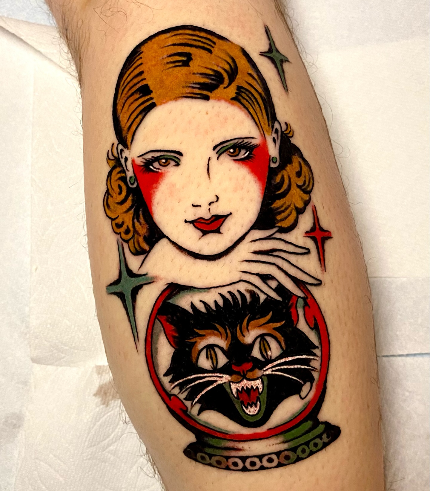 Woman with cat American traditional tattoo on the forearm by Haley Tucker, Sebastopol, California
