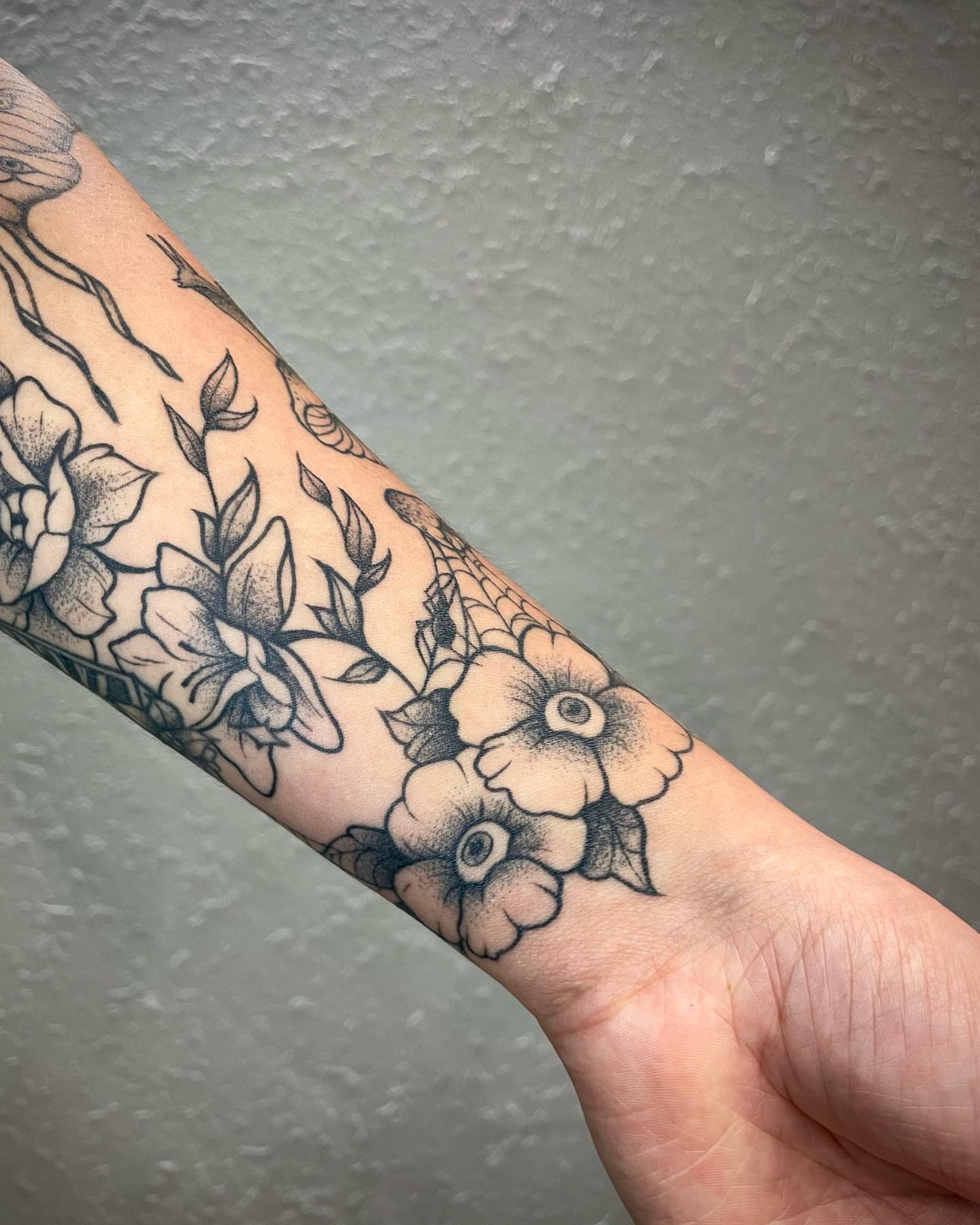 Floral bouquet dotwork tattoo on the forearm by Bryce Presley, Mission, Kansas