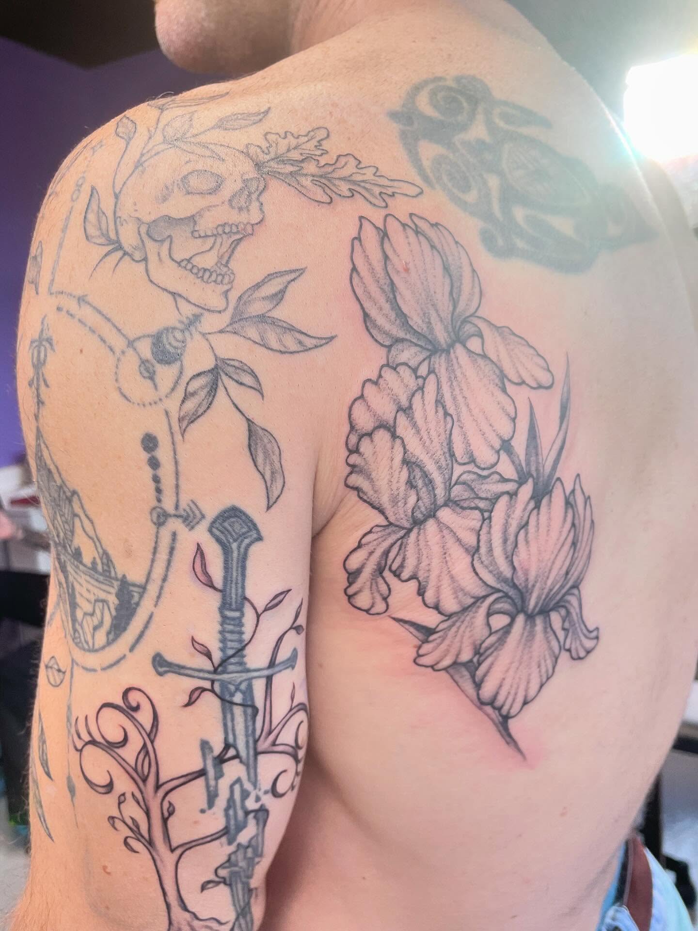 Floral arrangement realism tattoo on the shoulder by Christin Baumgart