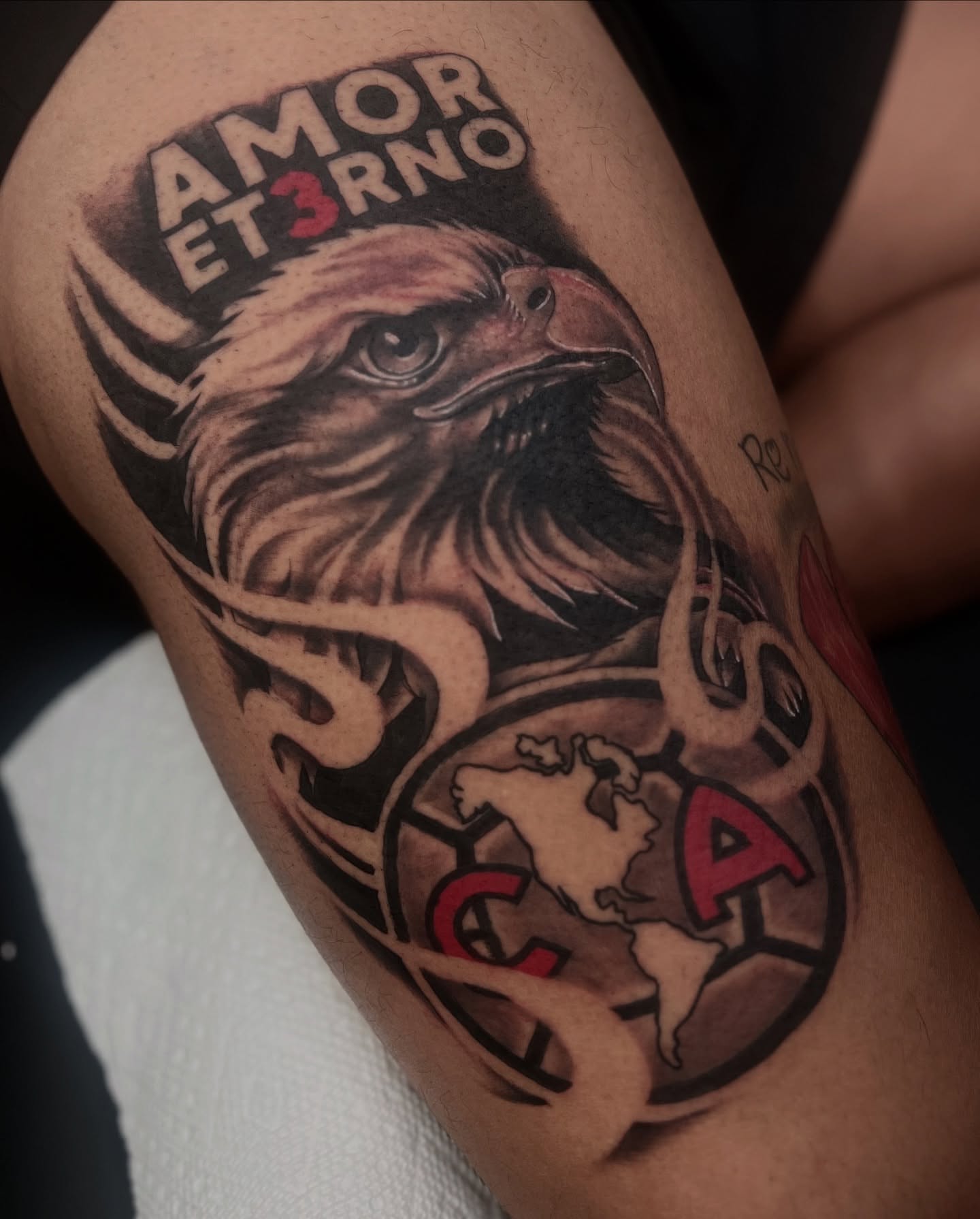 Eagle and soccer ball realism tattoo on the thigh by Moose