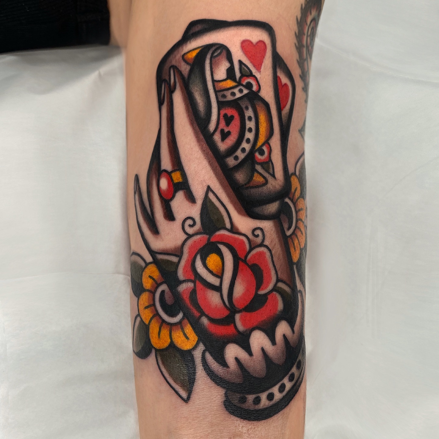 Queen of hearts American traditional tattoo on the forearm by Wes Hoffman