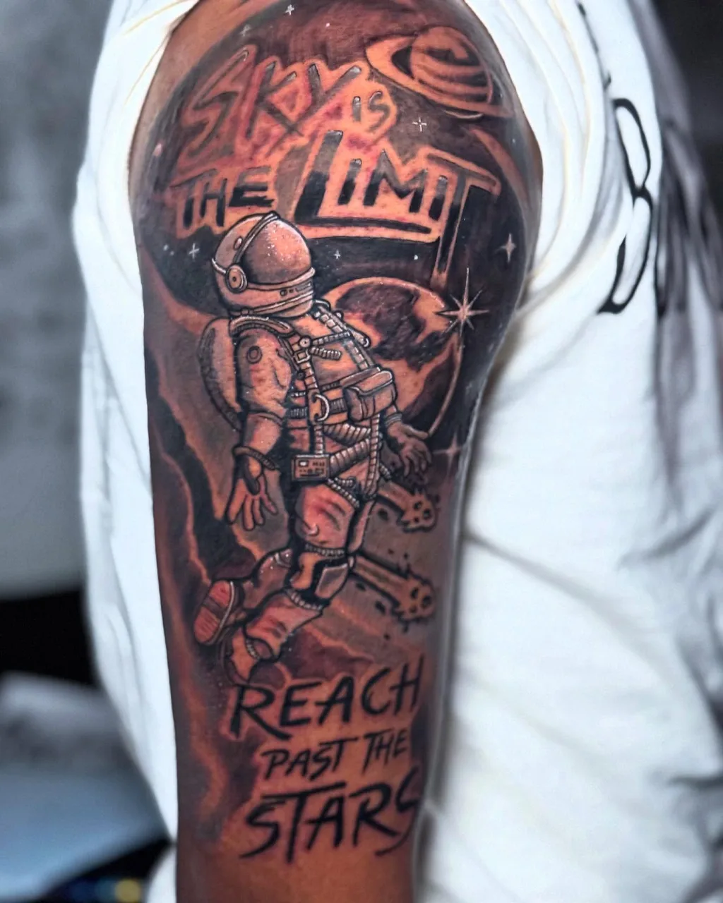 Astronaut in space realism tattoo on the forearm by Eldaddy