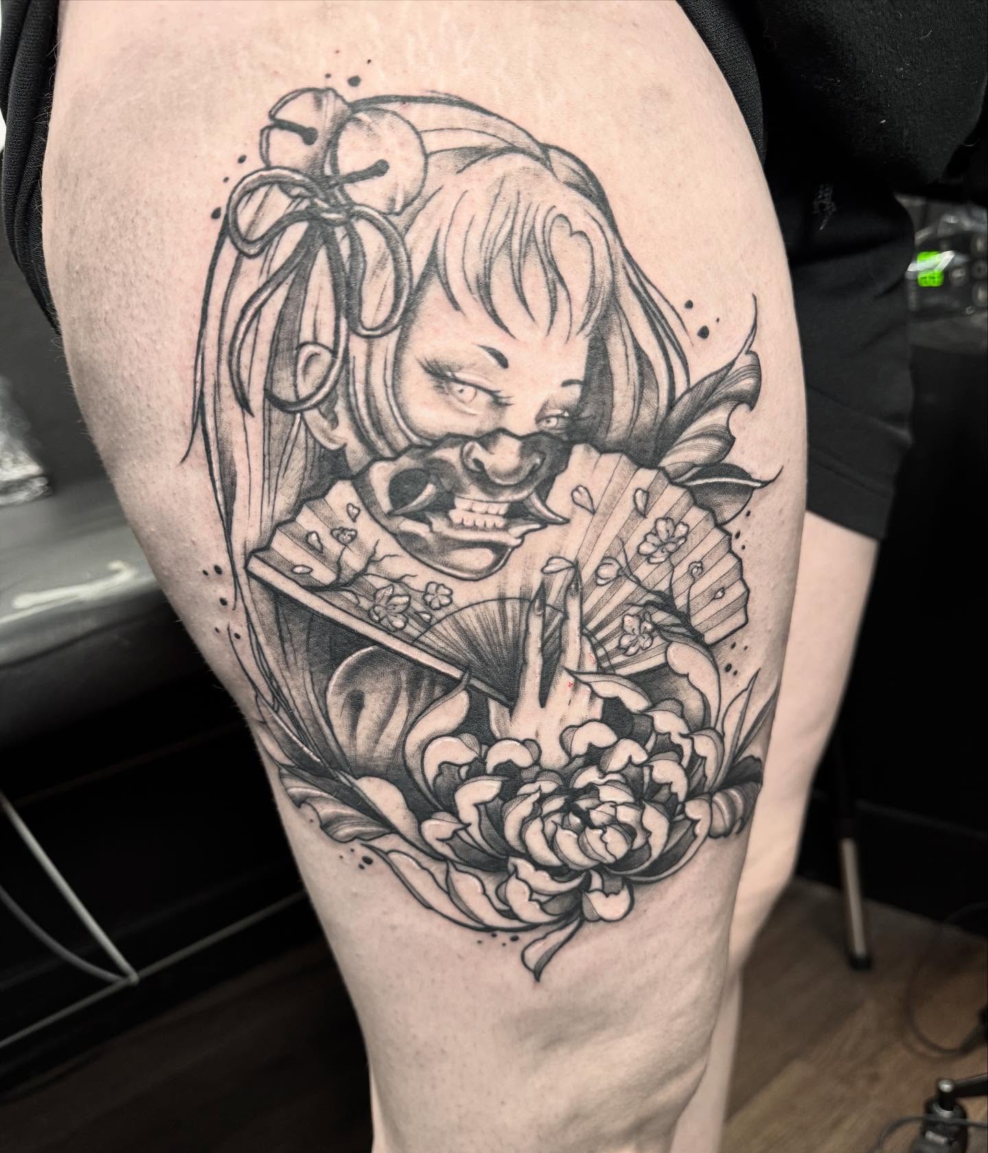 Clown and flowers realism tattoo on the thigh by 𝔈𝔯𝔦𝔫 𝔊𝔦𝔩𝔩𝔦𝔩𝔞𝔫𝔡, Springfield, Ohio