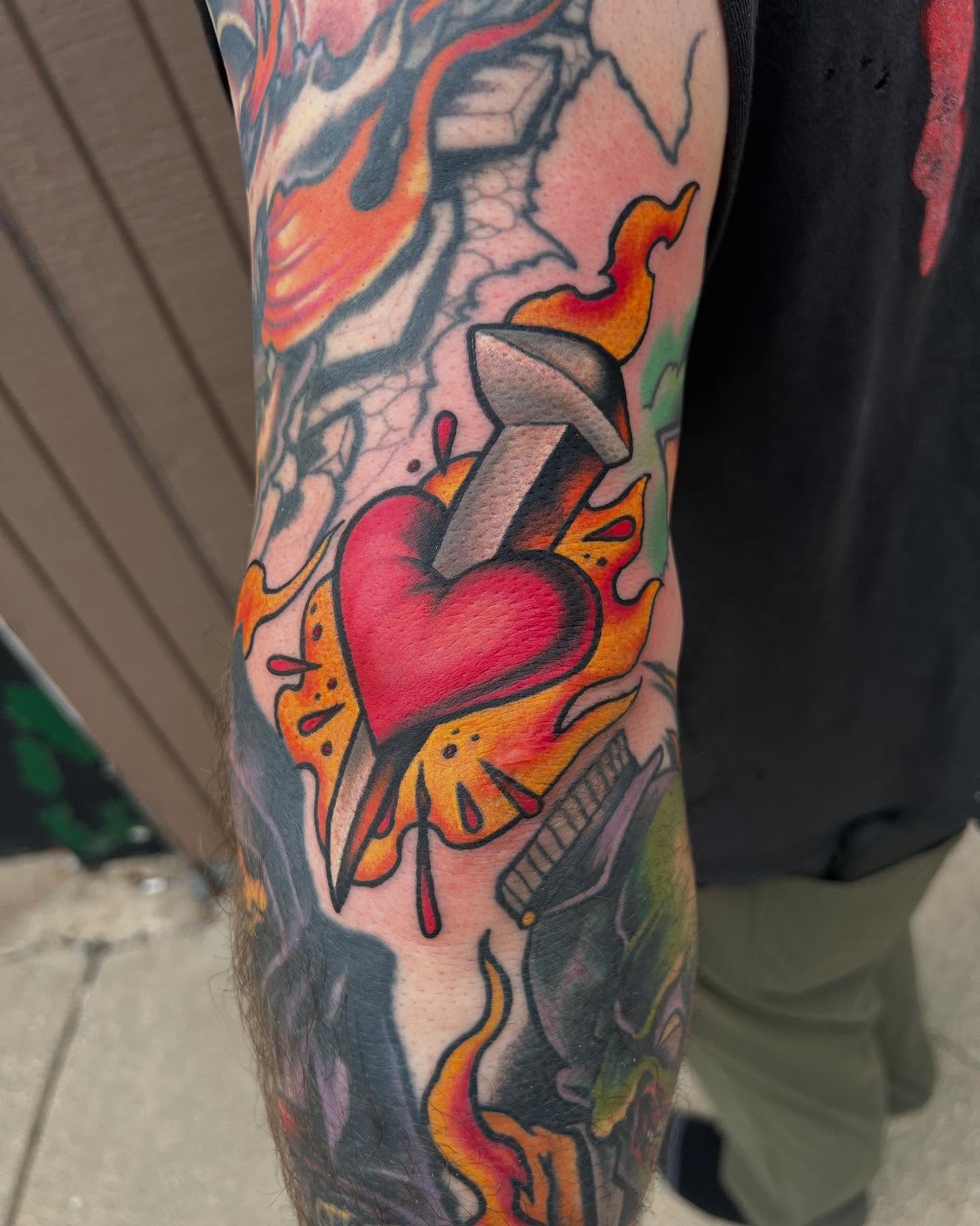 Heart with arrow American traditional tattoo on the forearm by Kevin Starai