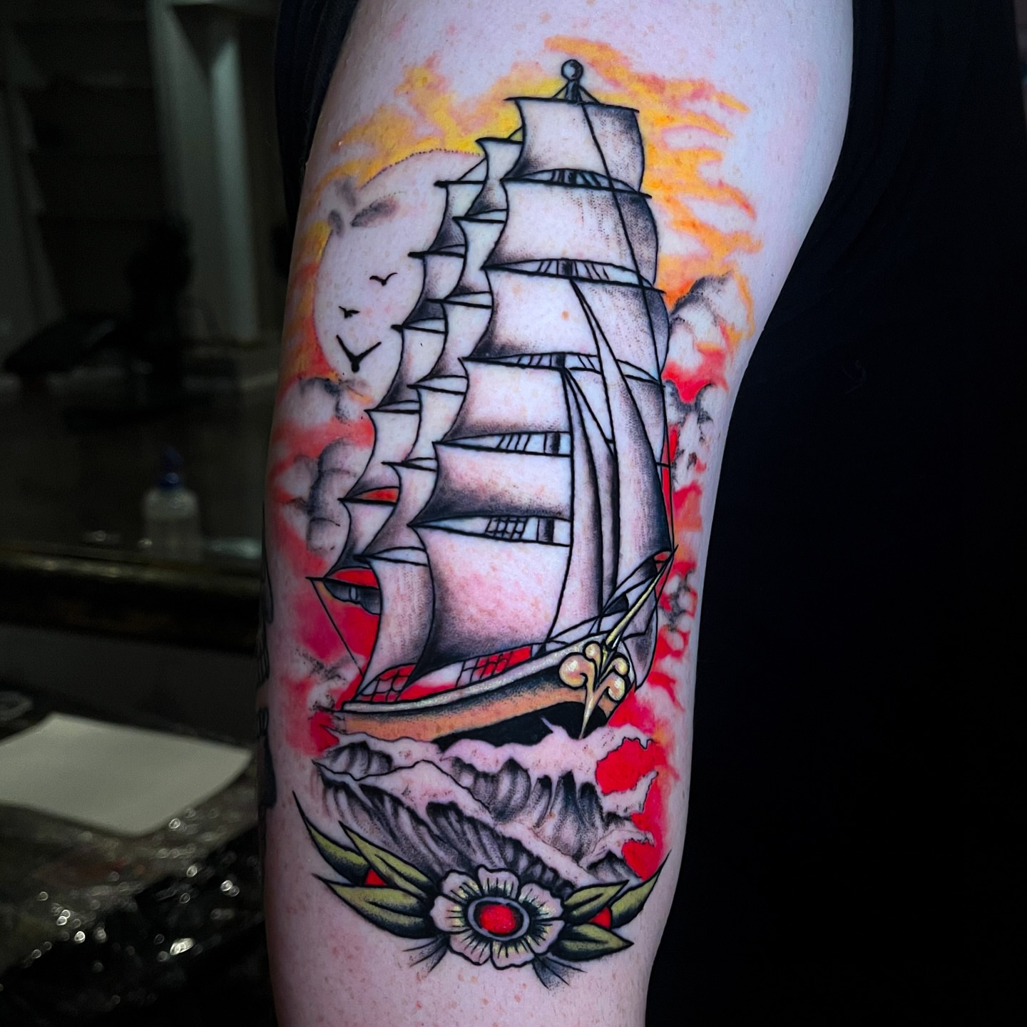Sailboat and flower American traditional tattoo on the forearm by Miguel Henrik