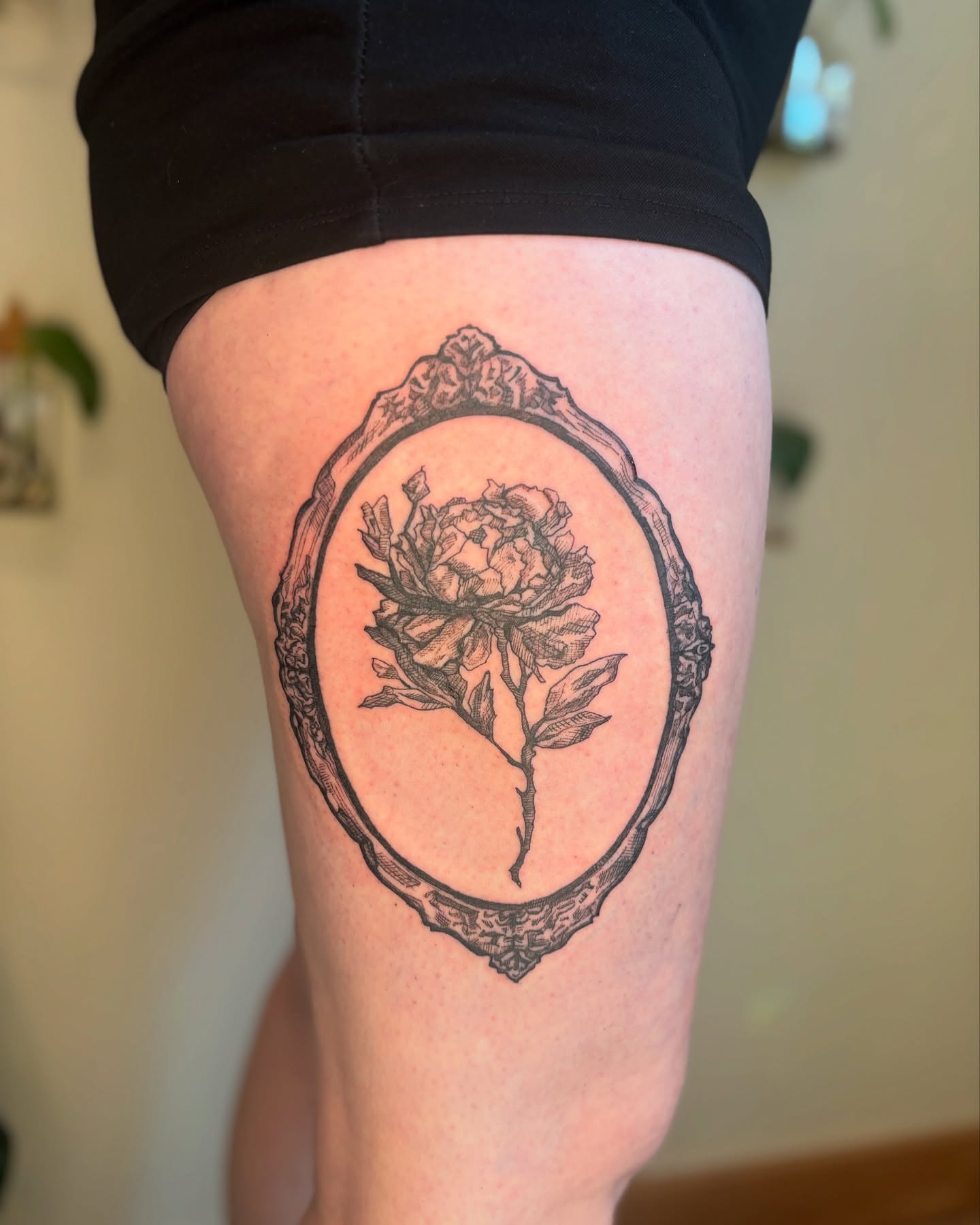 Peony in frame black and grey tattoo on the thigh by Wren Cavanaugh Tattoos, Seattle, Washington
