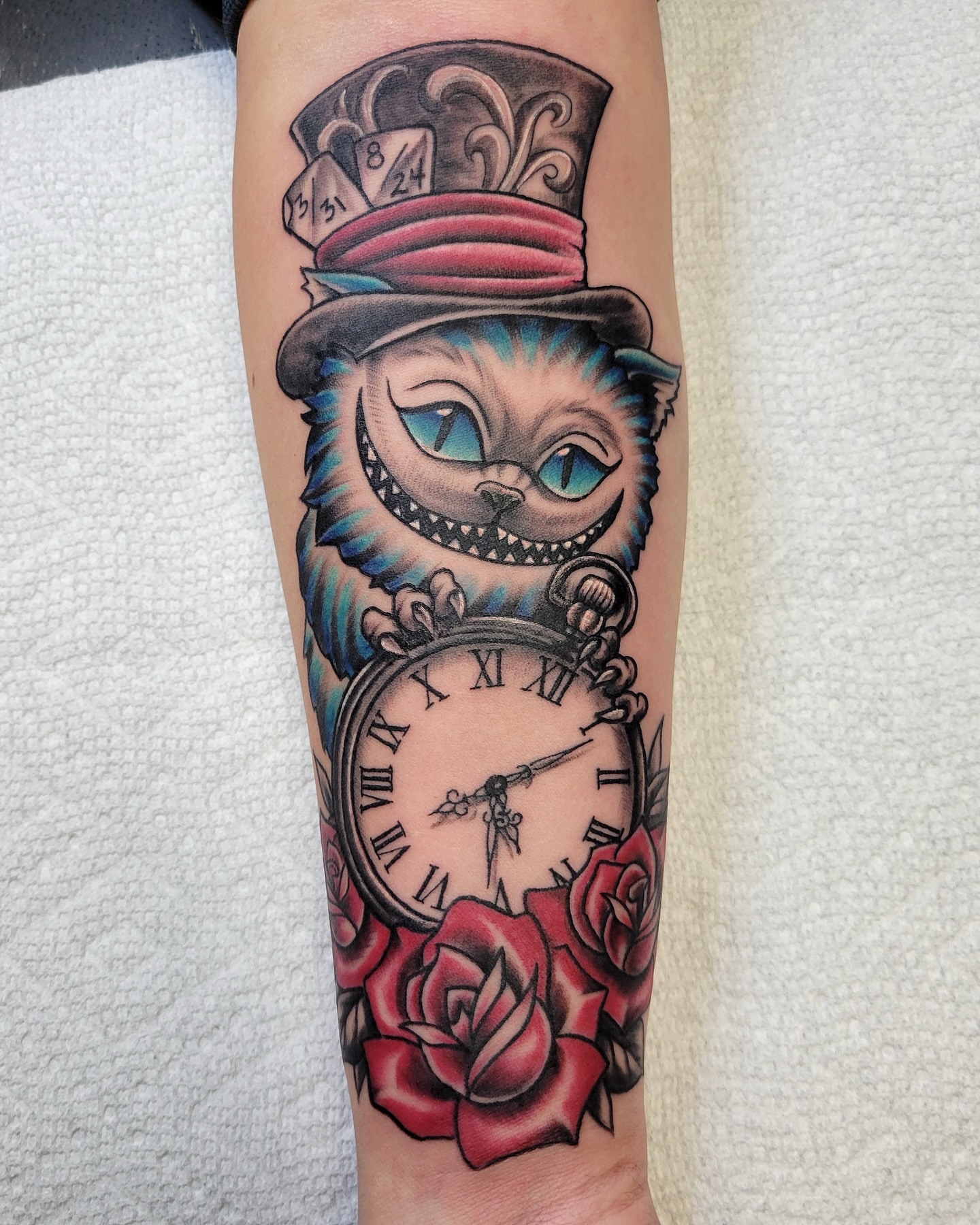 Cheshire cat American traditional tattoo on the forearm by Douglas