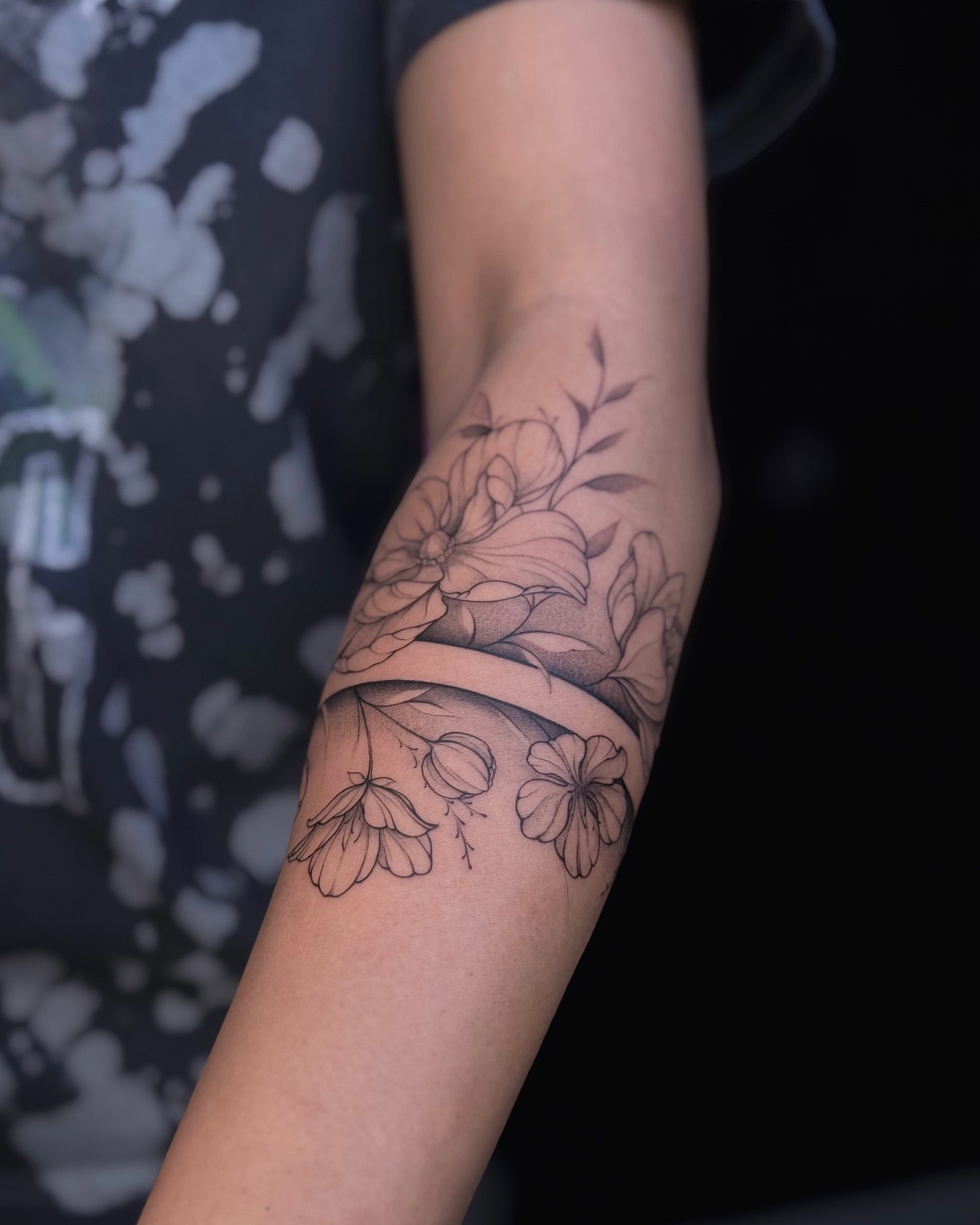 Floral bouquet black and grey tattoo on the forearm by Daria