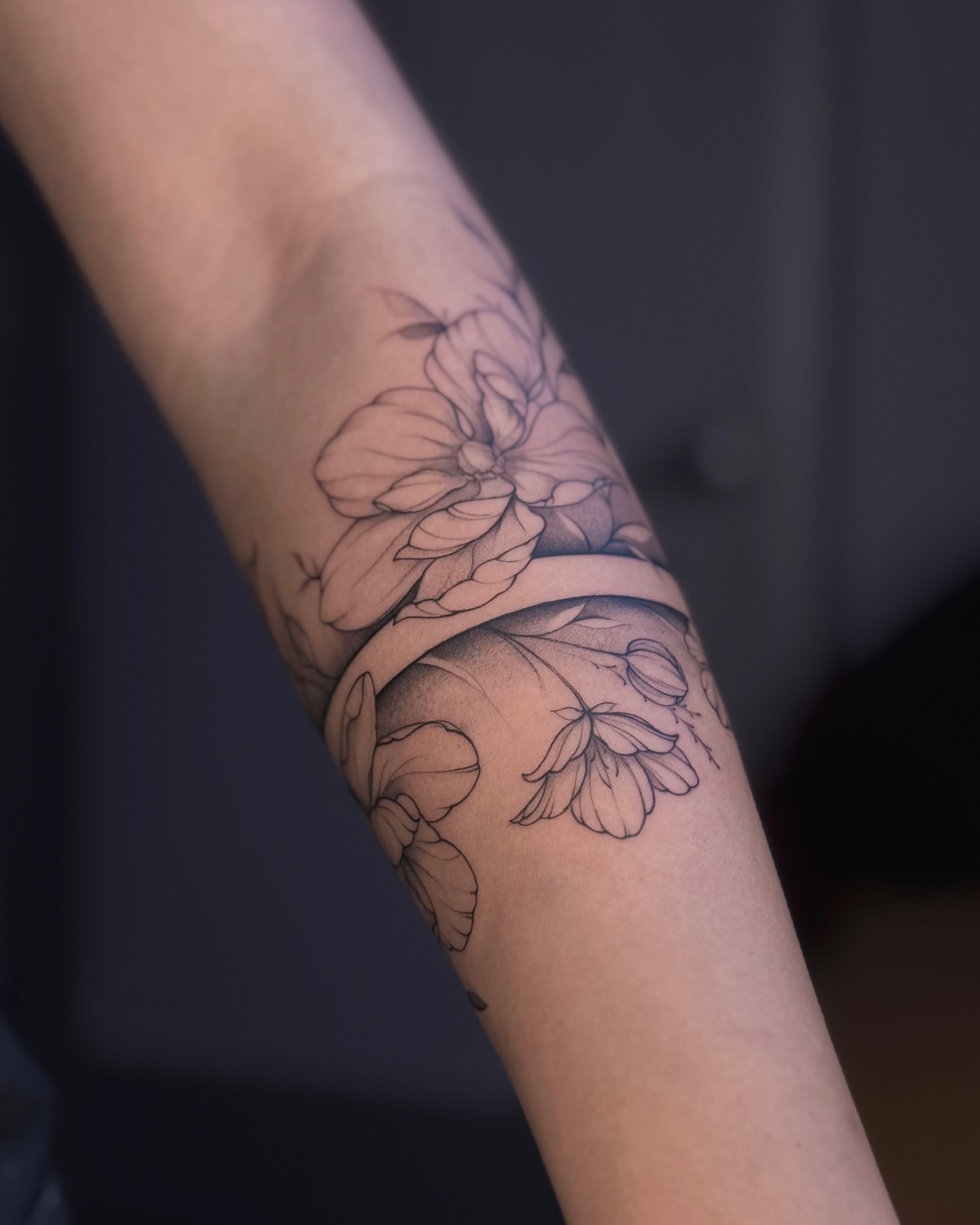 Floral bouquet black and grey tattoo on the forearm by Daria