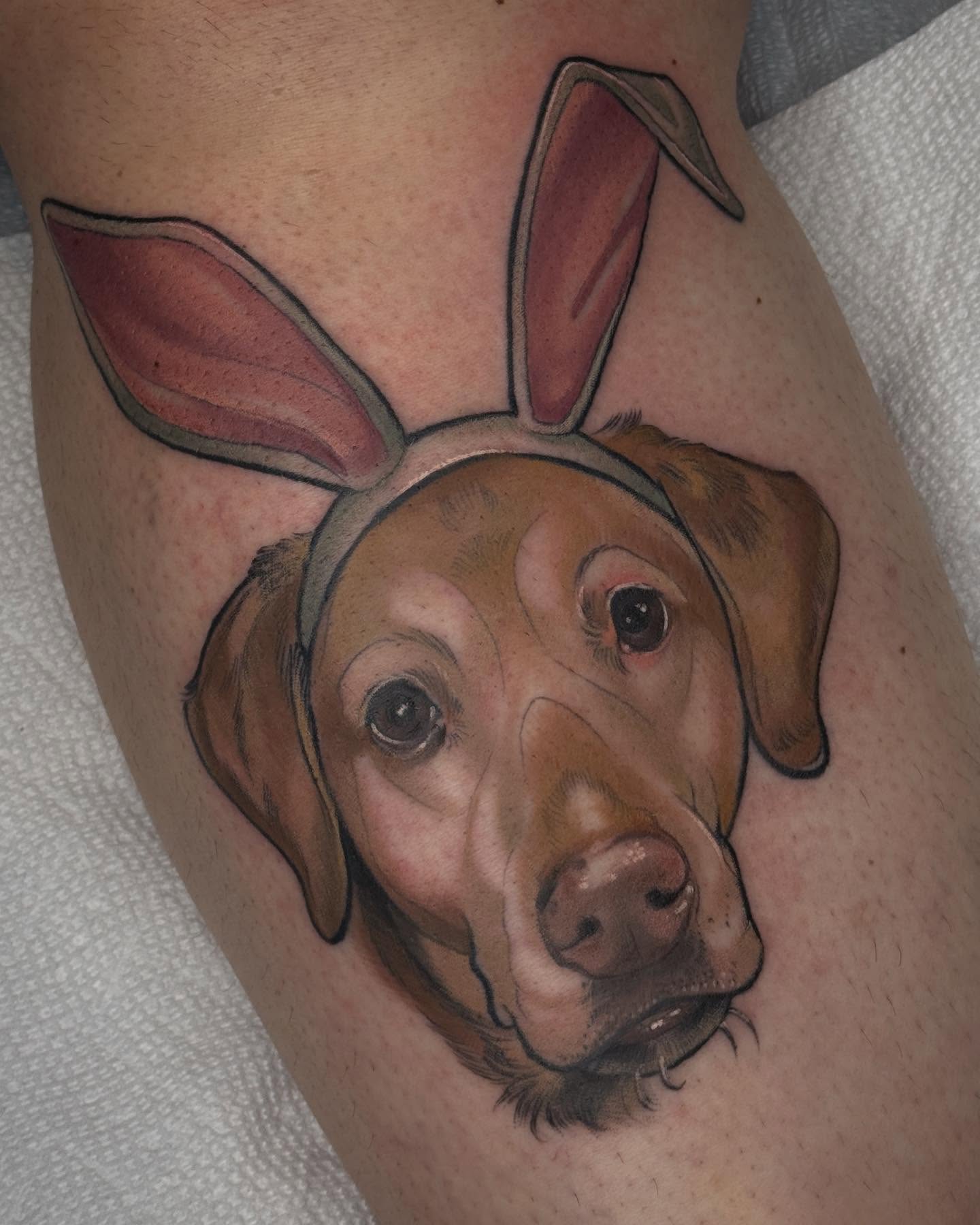 Dog wearing bunny ears realism tattoo on the thigh by Rachael Shelly