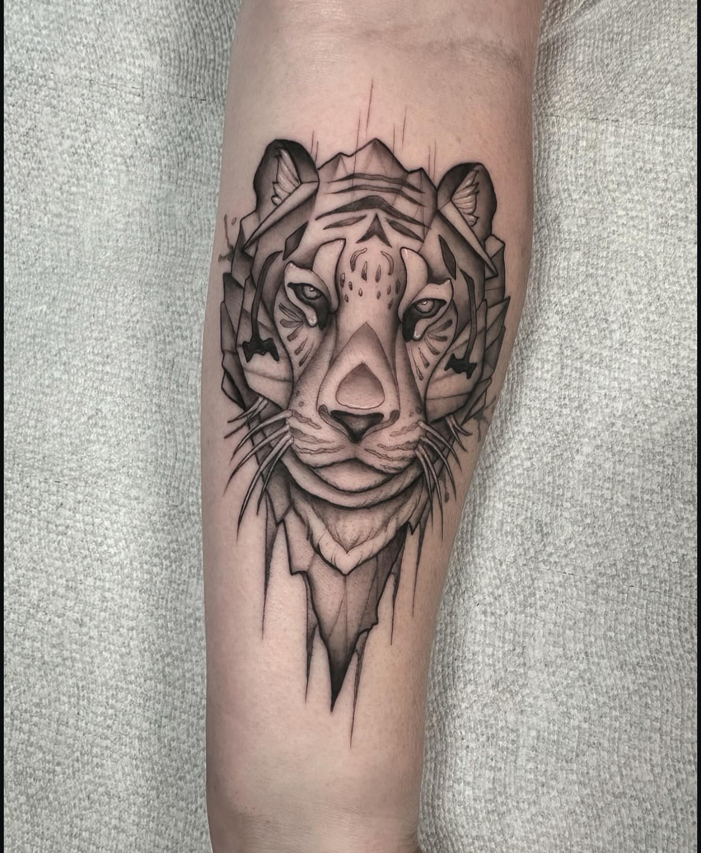 Tiger geometric tattoo on the forearm by Lawrence Edwards