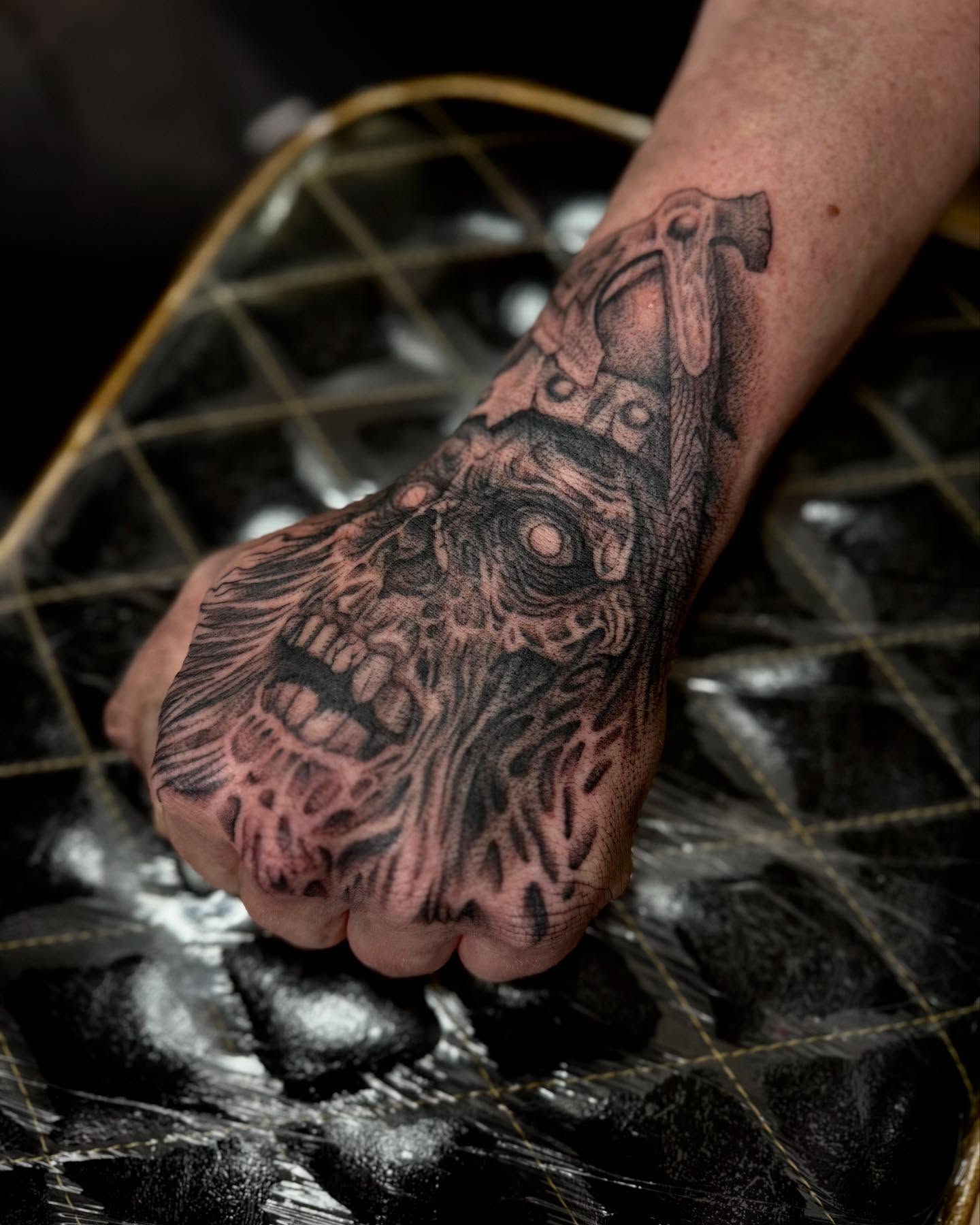 Cyborg fist geometric tattoo on the hand by William Worley