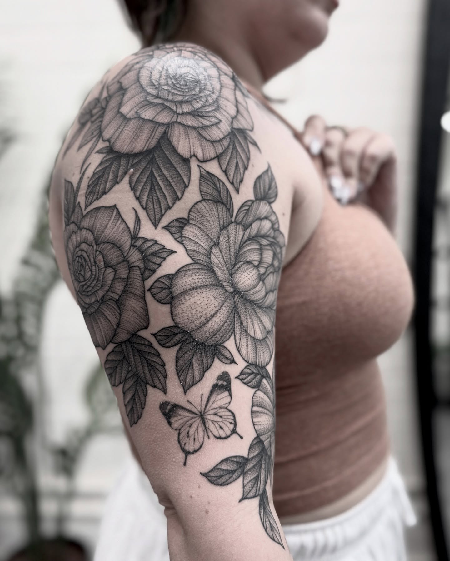 Flowers and butterfly realism tattoo on the shoulder by Alex Shakuto Tattoo