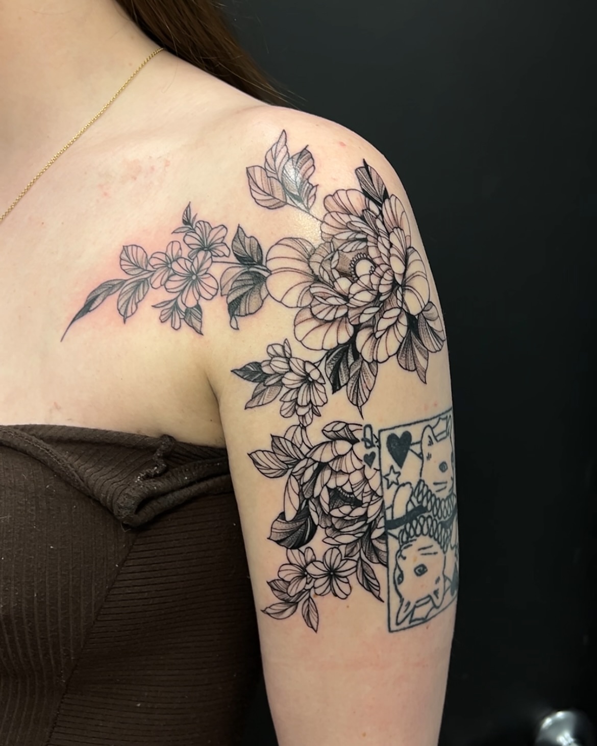 Floral bouquet black and grey tattoo on the shoulder by Lexi Baker