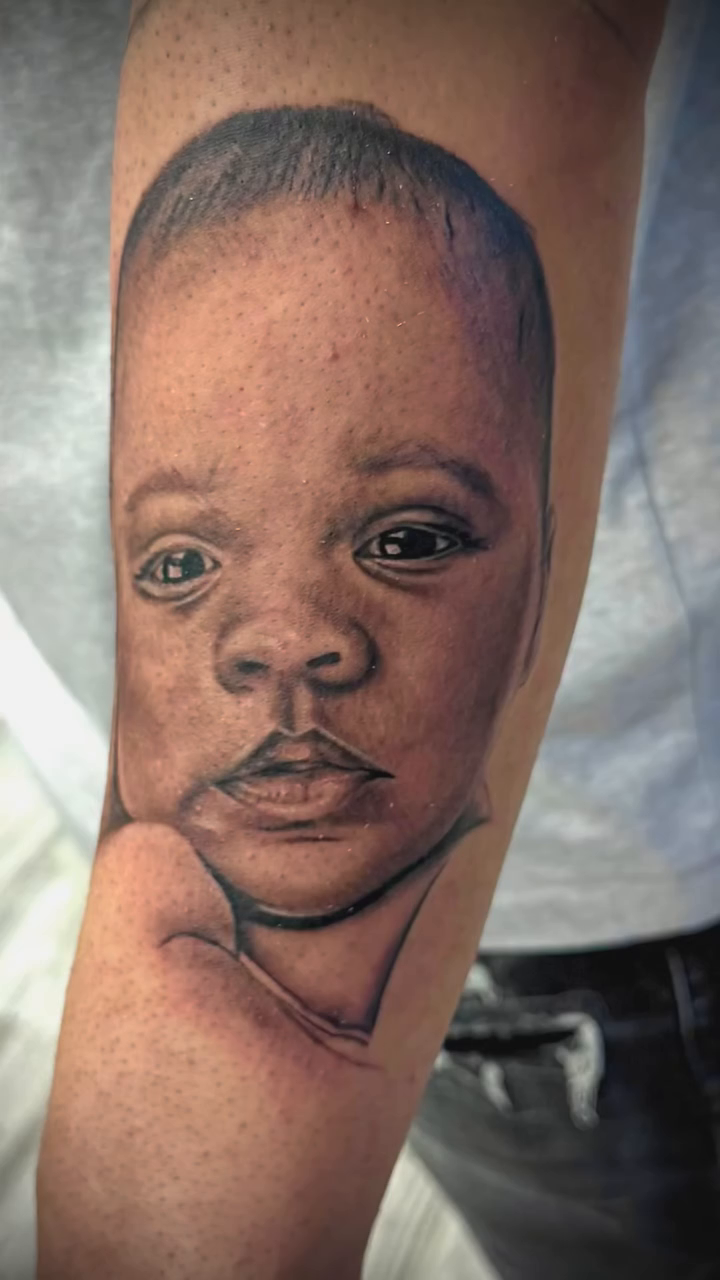 Portrait of a baby realism tattoo on the forearm by Luis Cabrera, Cleveland, Ohio