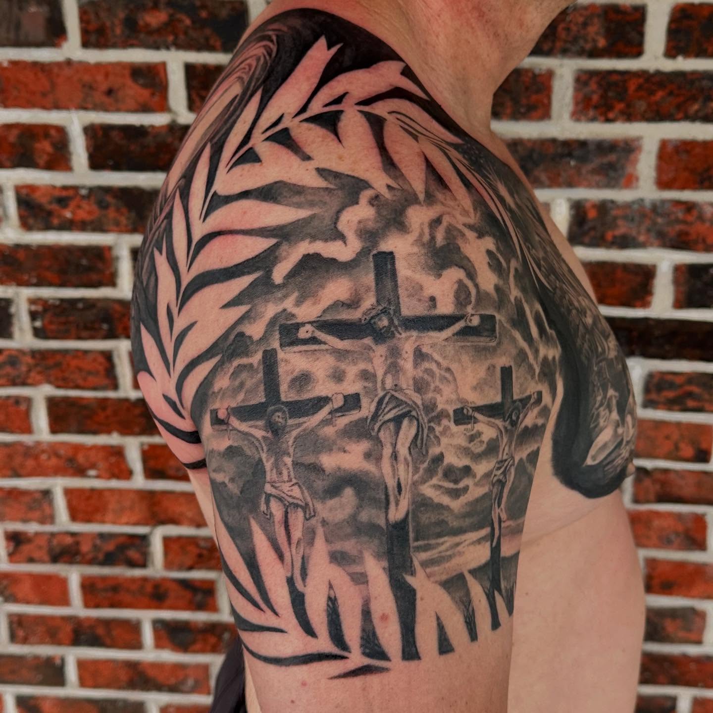 Religious crucifixion scene realism tattoo on the shoulder by Abigail Townsend