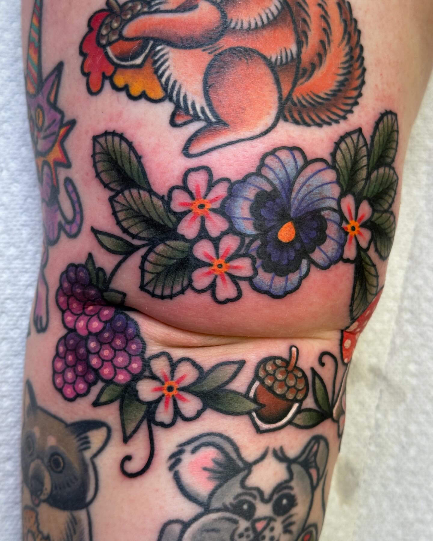 Floral and animal motifs American traditional tattoo on the forearm by Ginny Marie Kalnasy
