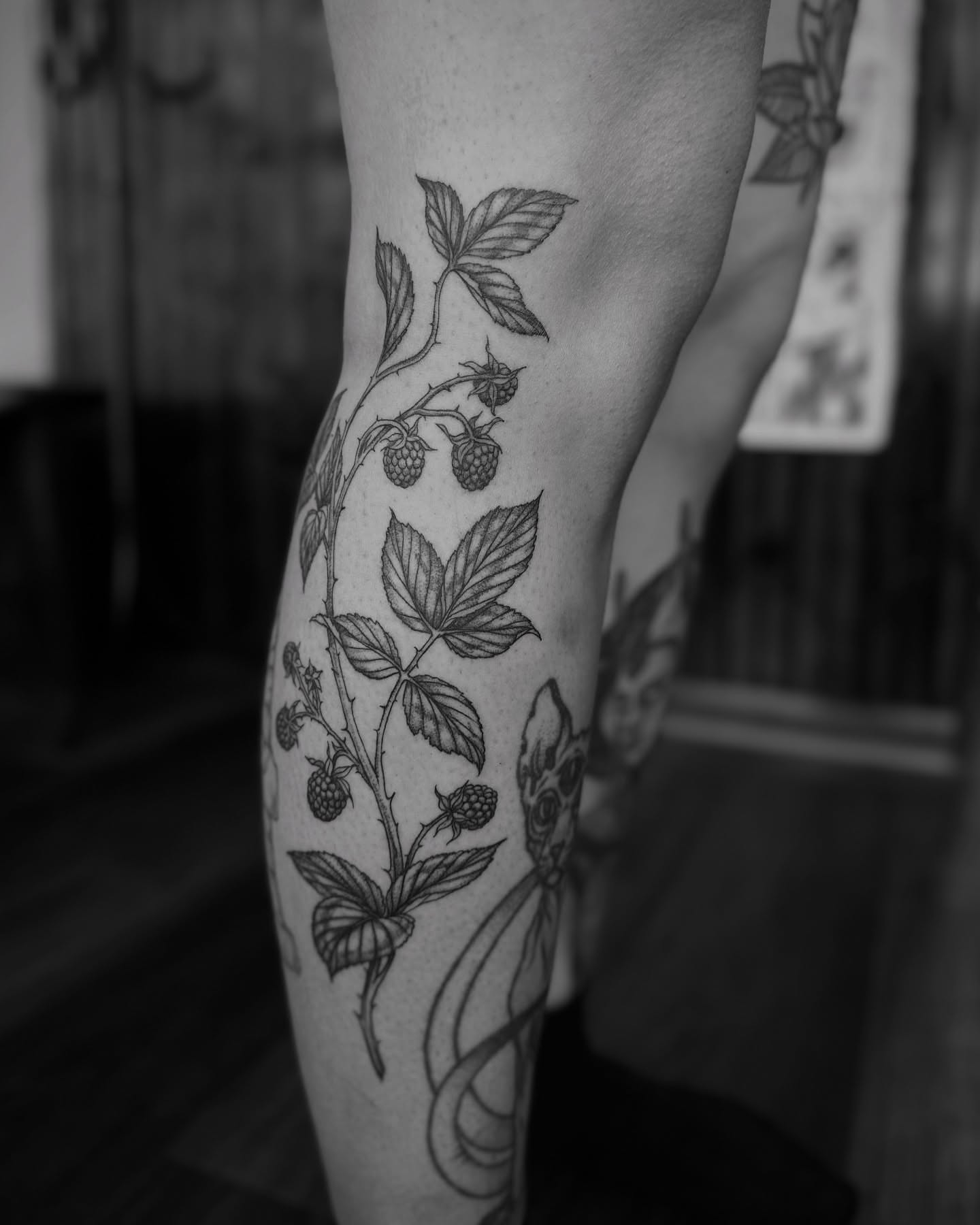 Raspberry plant black and grey tattoo on the forearm by Alex Brooke