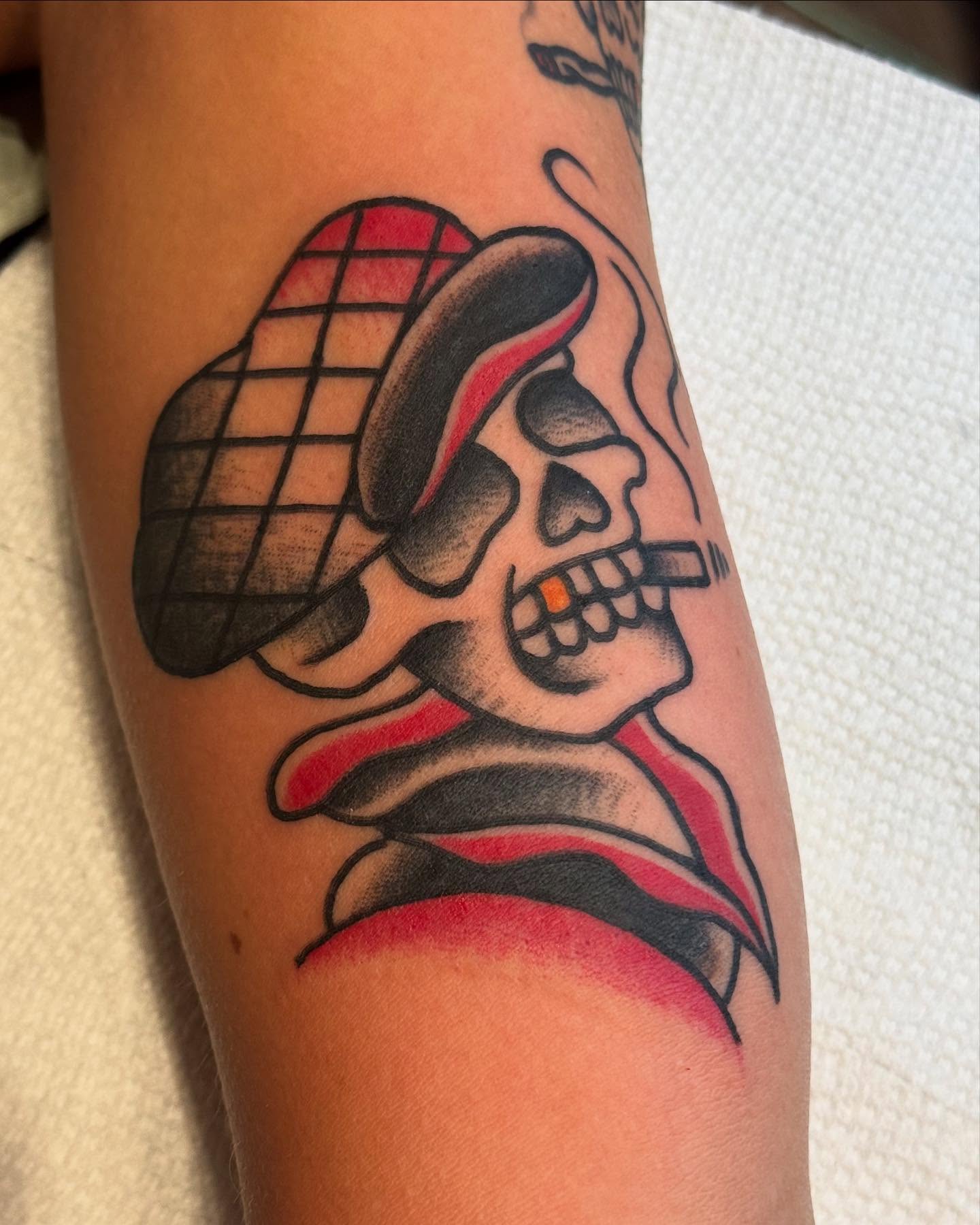 Skull wearing hat American traditional tattoo on the forearm by Rob Keiuf