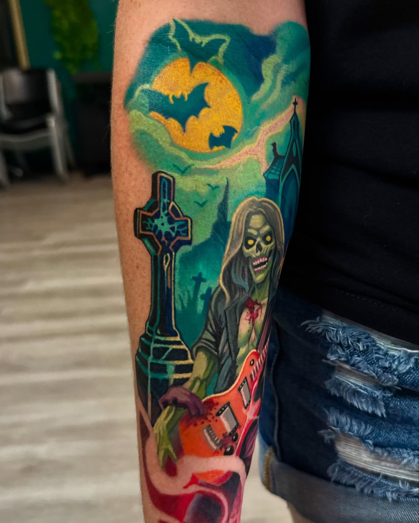 Zombie with guitar dark realism tattoo on the forearm by Kyle hodge