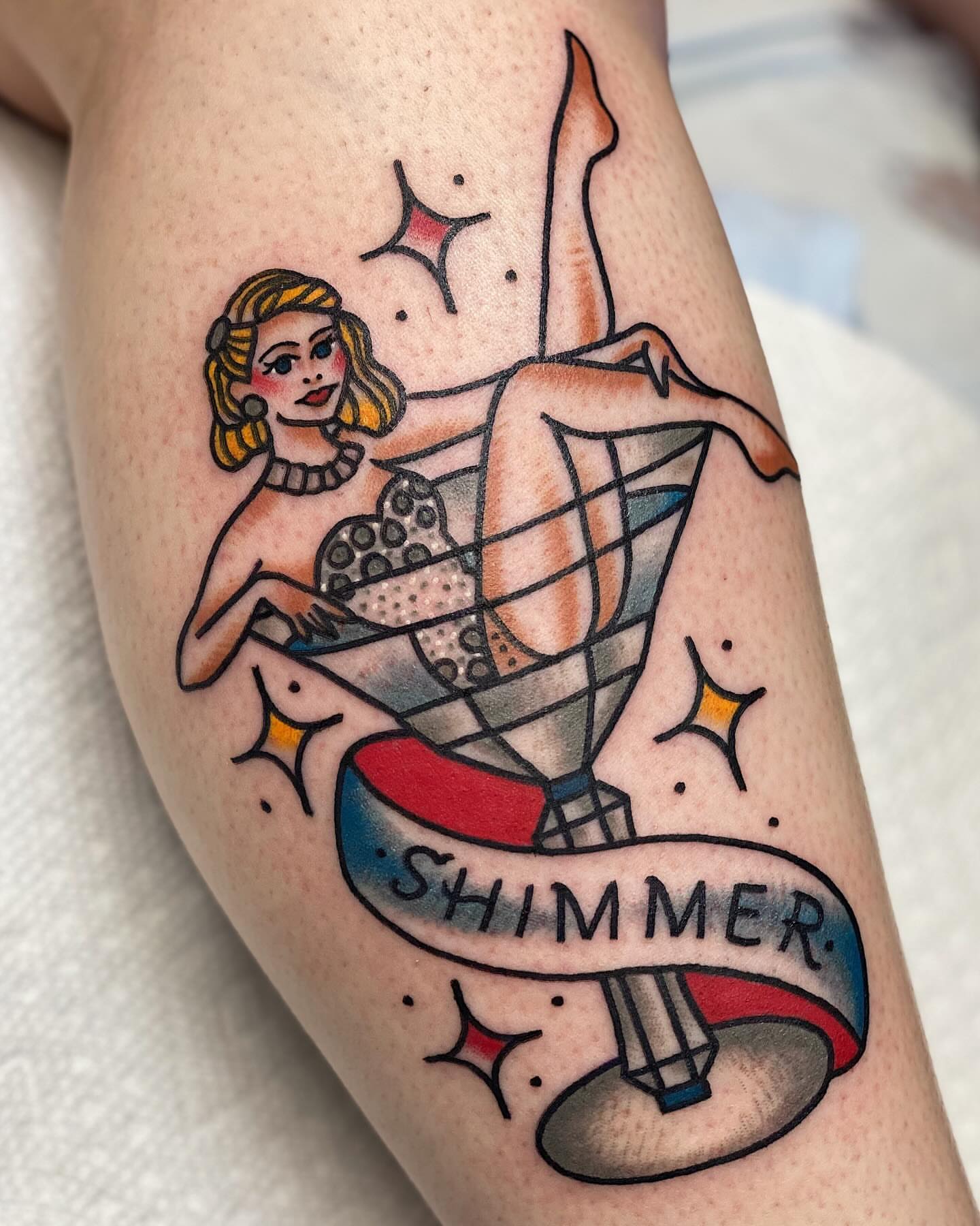 Pin-up girl American traditional tattoo on the thigh by Dakota Amato