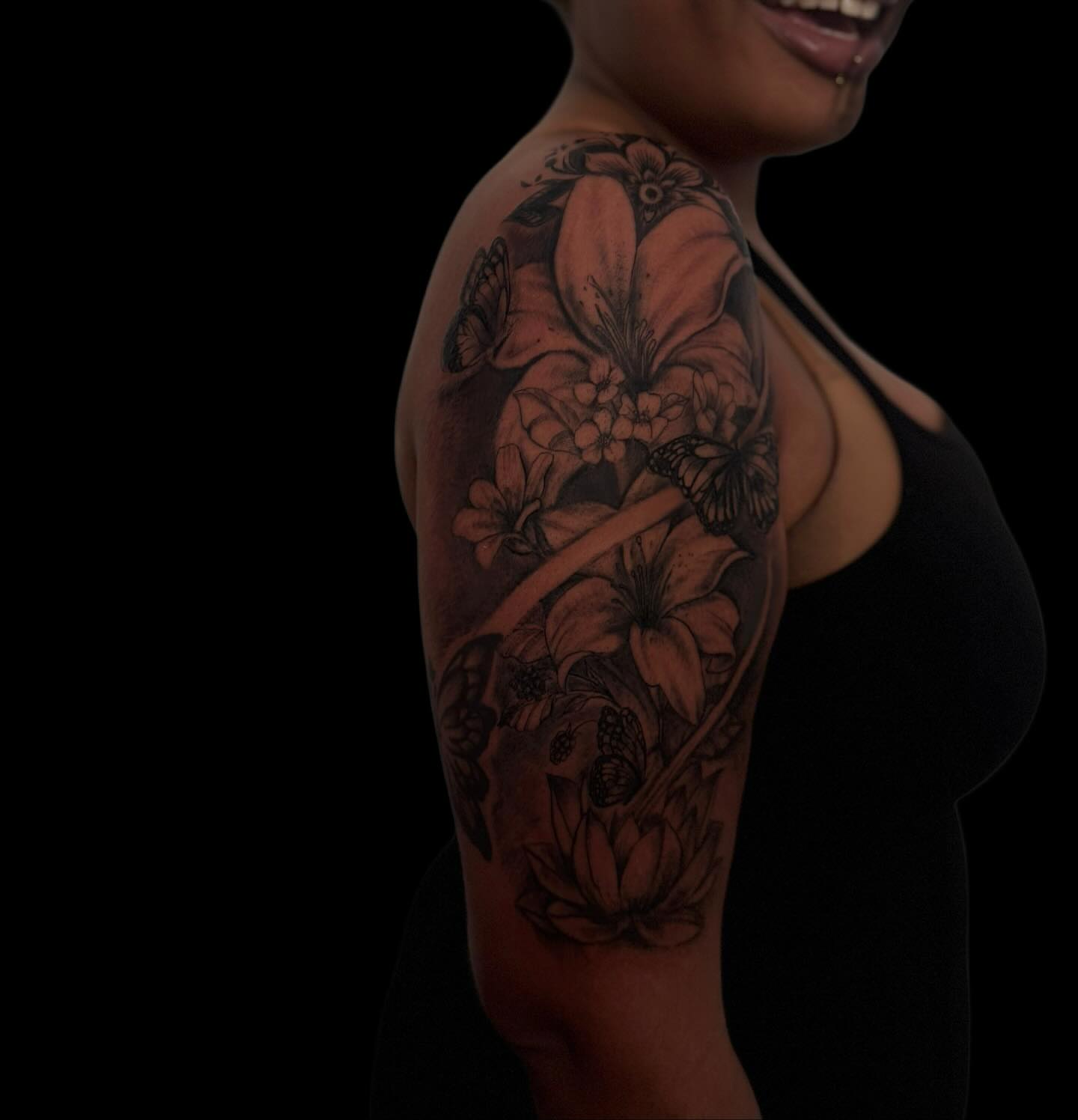 Floral arrangement black and grey tattoo on the upper arm by Asia Rene Tattoos👑