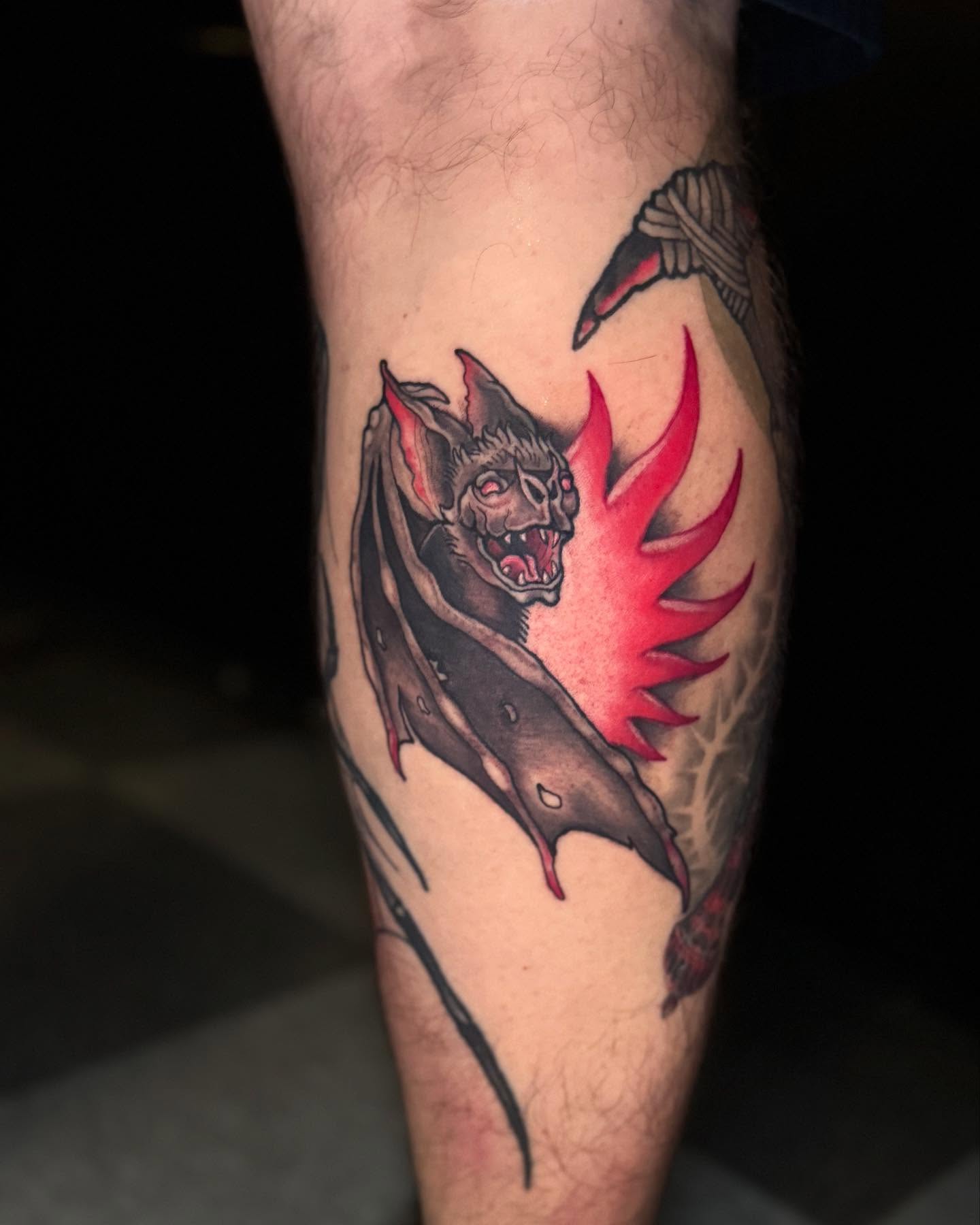 Bat with flames dark realism tattoo on the forearm by Brandon Seven