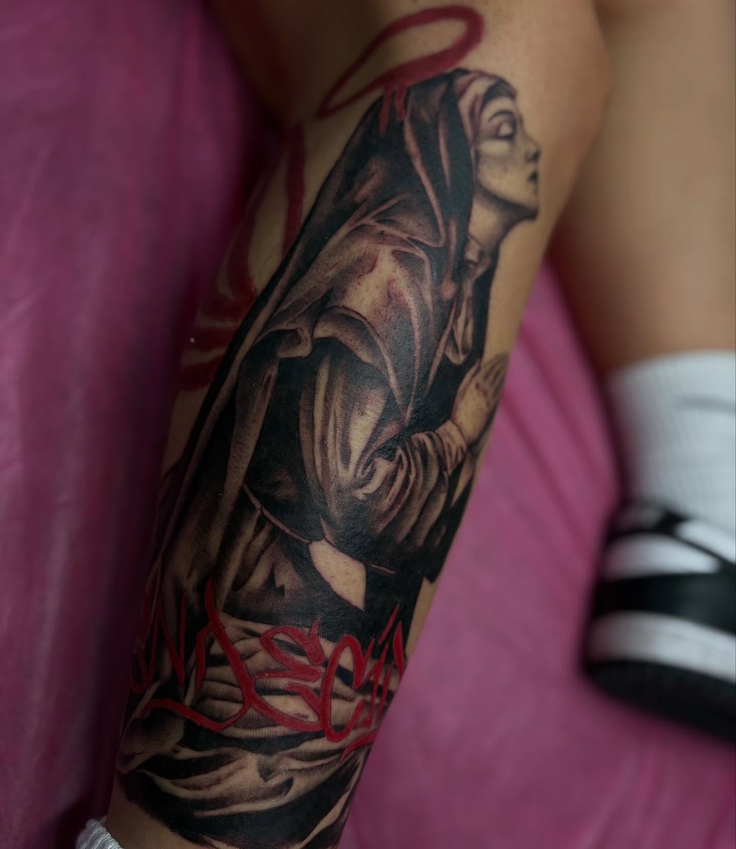 Religious figure realism tattoo on the forearm by Alexandria