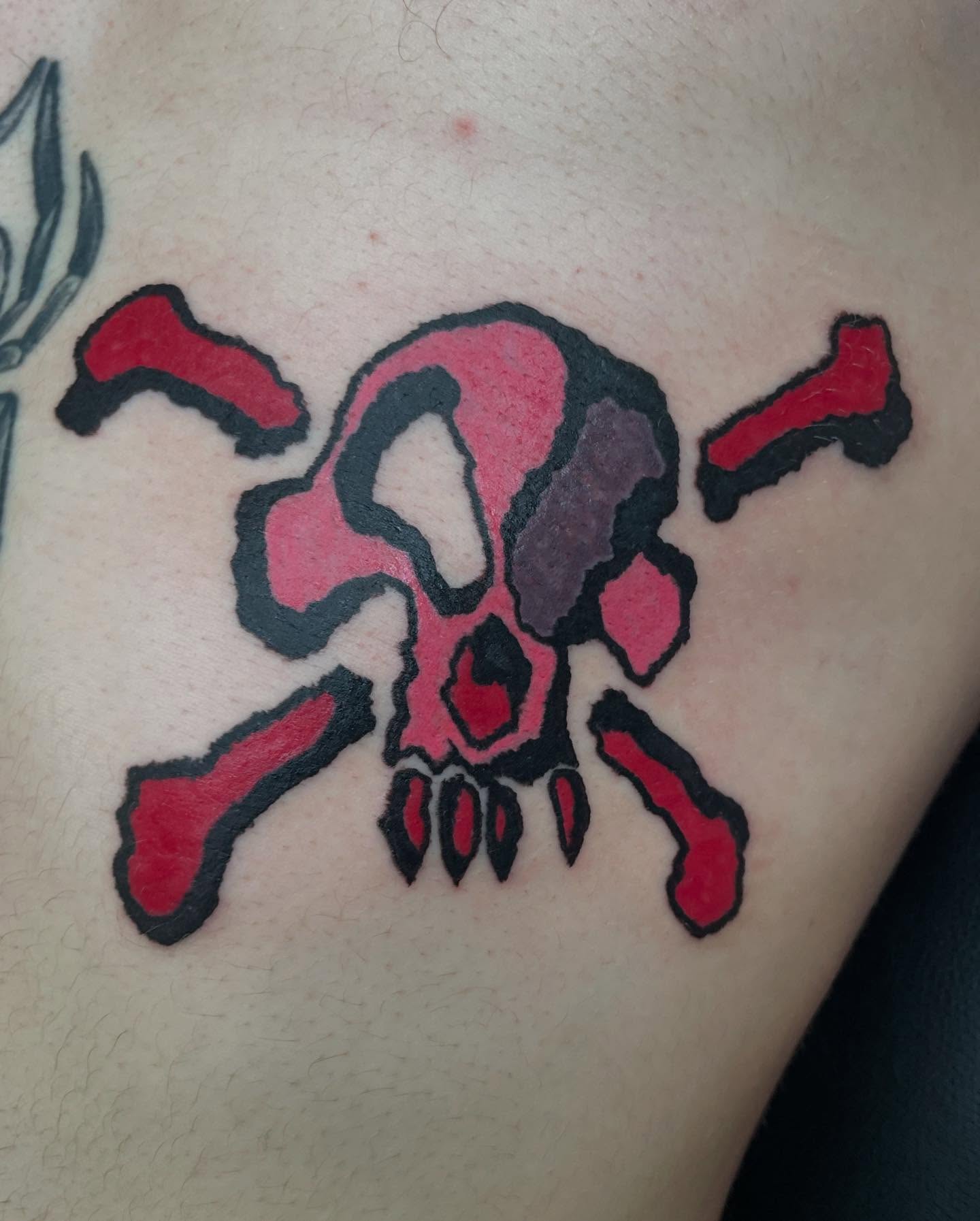 Skull and crossbones American traditional tattoo on the thigh by @emotionalthugtattoo
