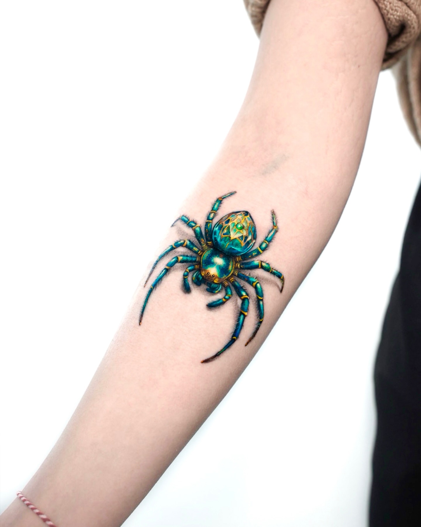 Spider geometric tattoo on the forearm by serenay akçiçek